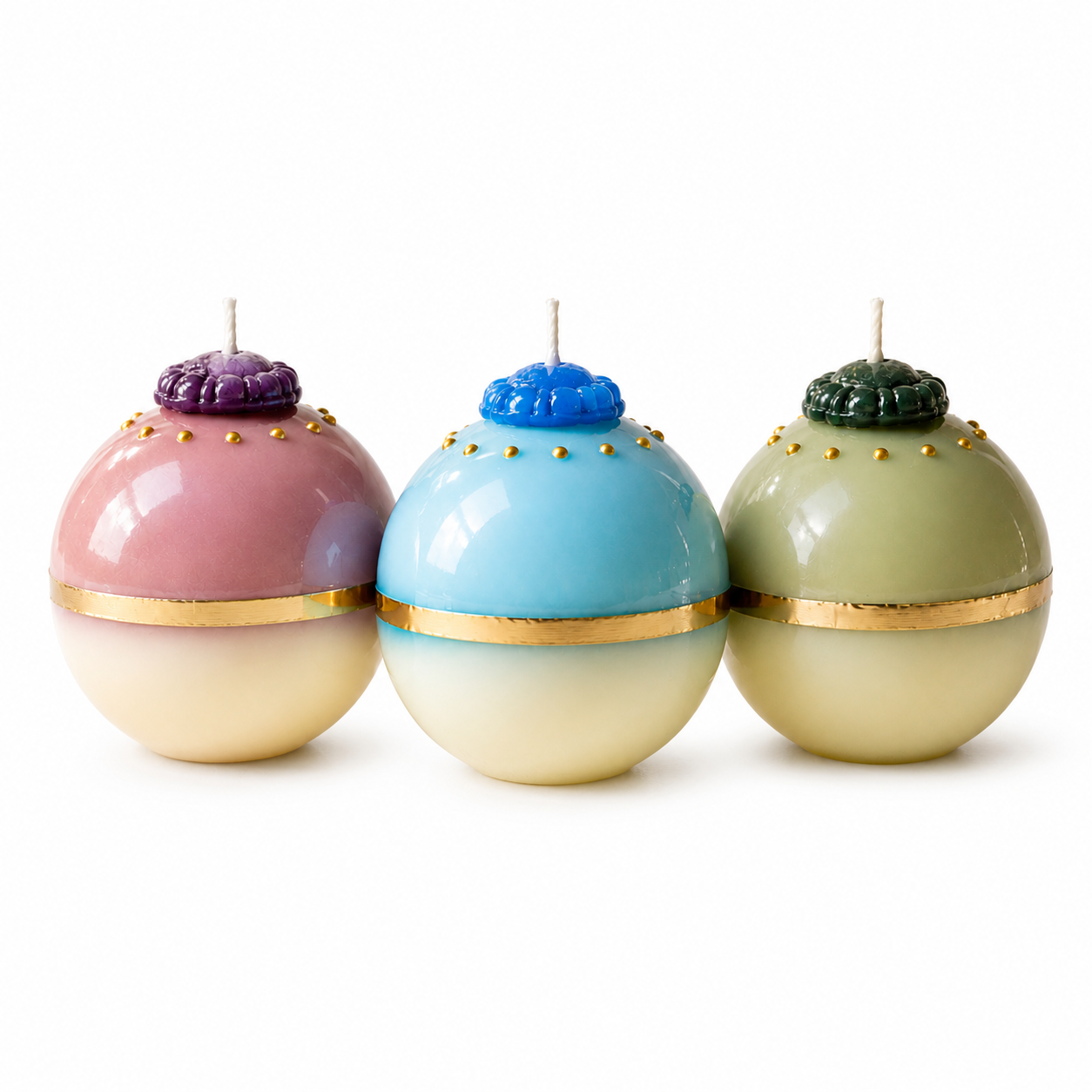 Decorative sphere candle trio with gold accents on clean white background