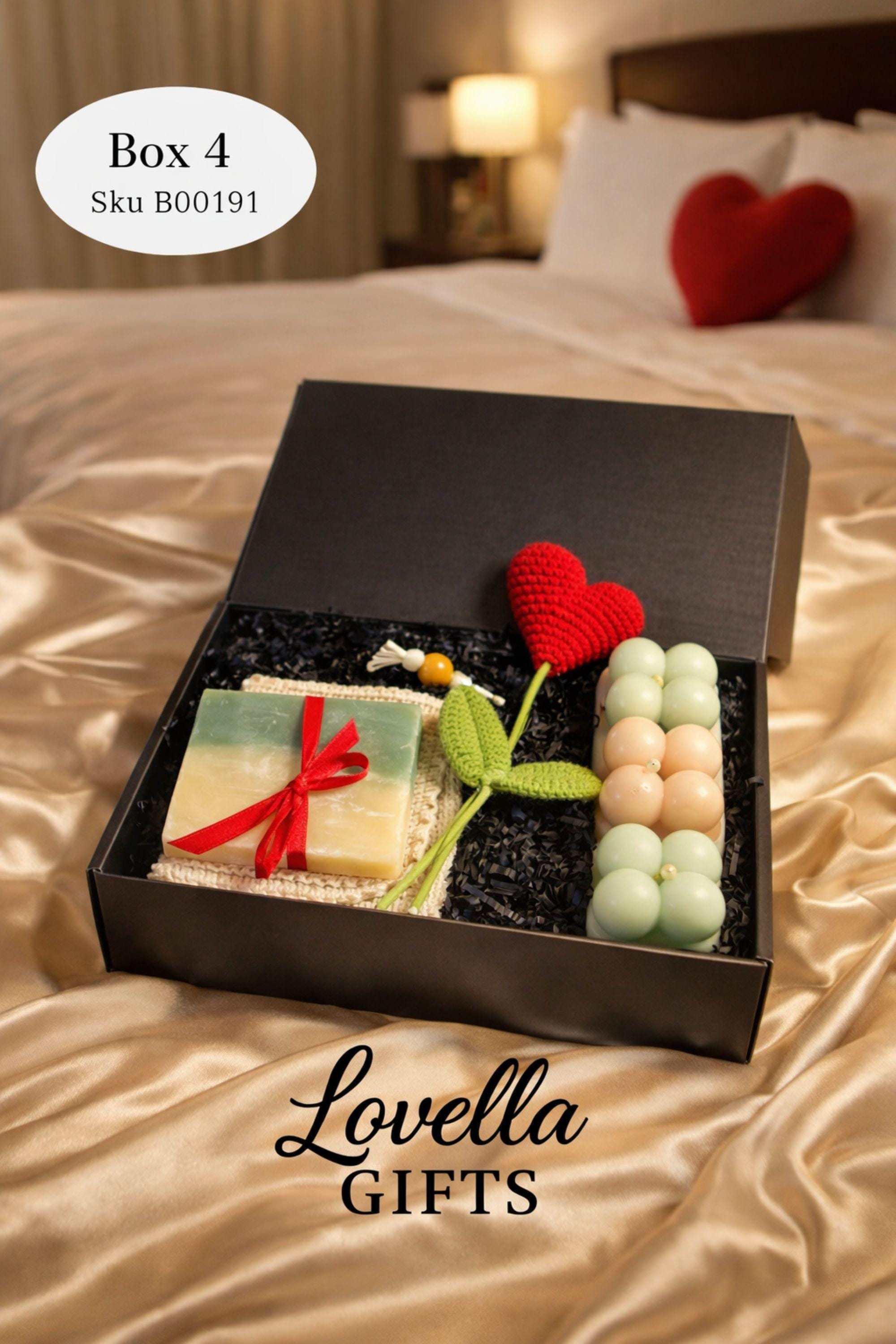 Cozy Valentine gift box with handmade soap tied with red ribbon, heart shaped candle, scented candle with dried flowers, bath salts in glass tubes, and knitted washcloth arranged in kraft gift box. Romantic self care gift for her, comfort care package, handmade Valentine’s Day gift, thinking of you box, ready to gift cozy relaxation set.