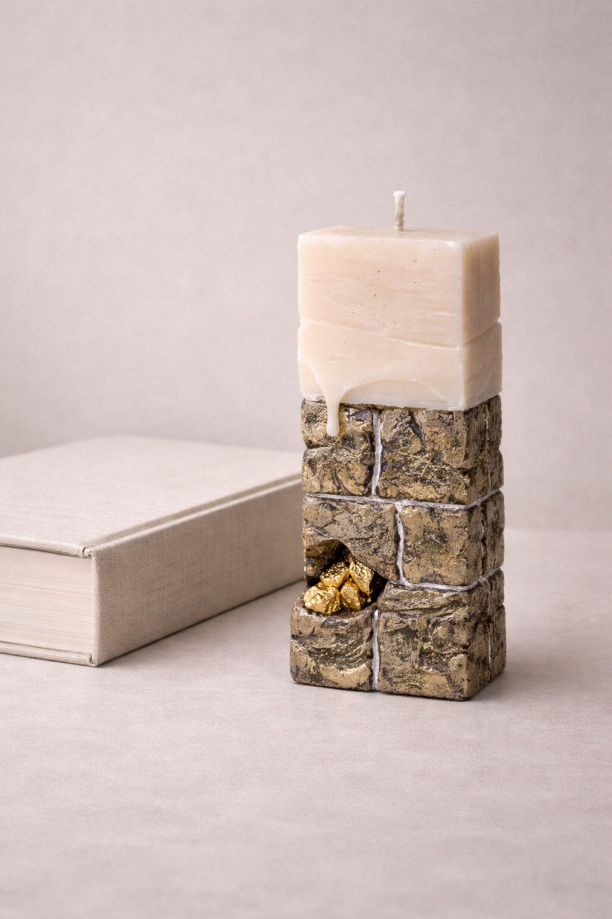 Luxury sculptural candle gift with stone texture and gold details, unique modern decor for stylish interiors.