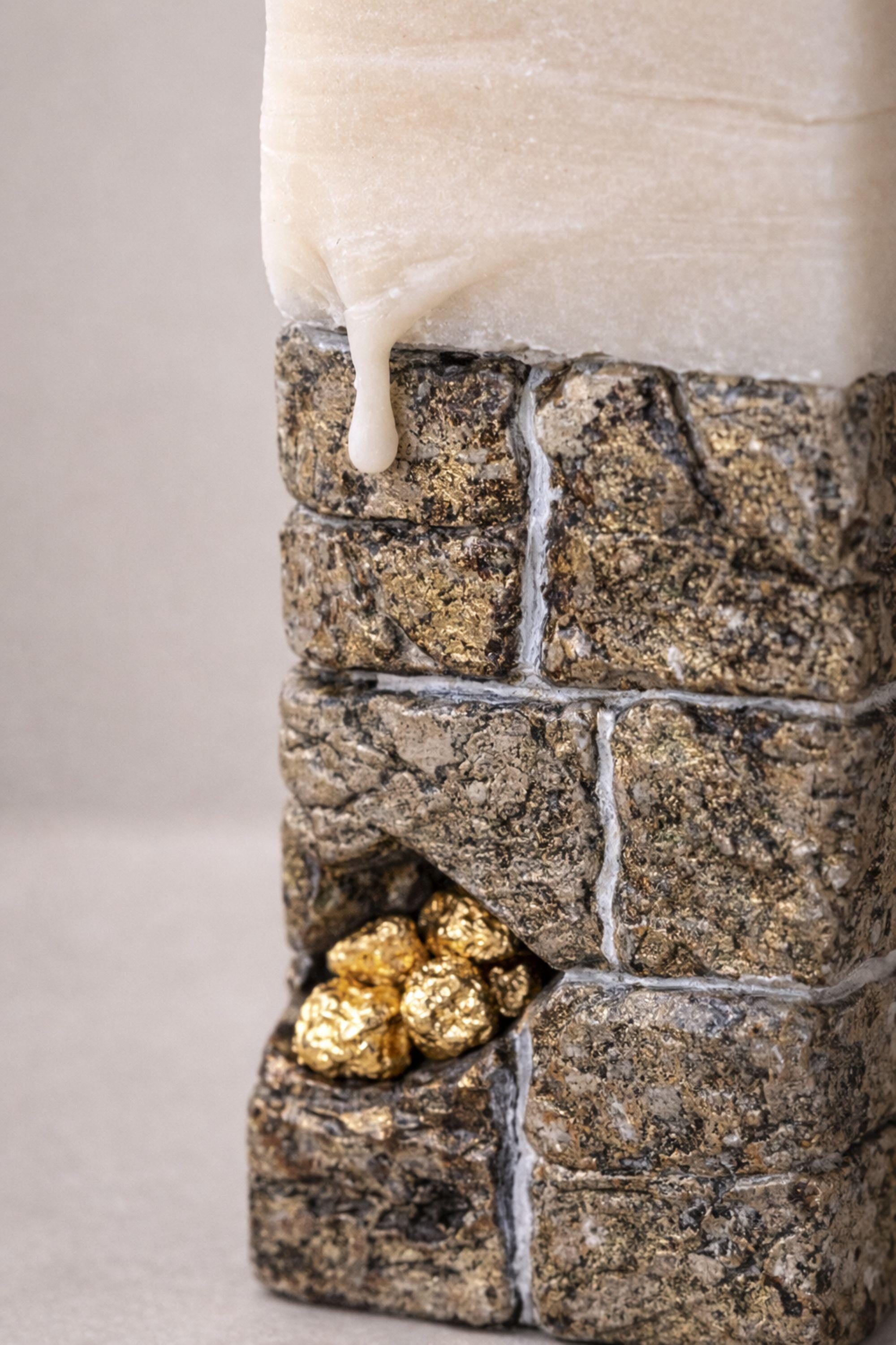 Luxury sculptural candle gift showcasing stone-inspired texture and subtle gold details.