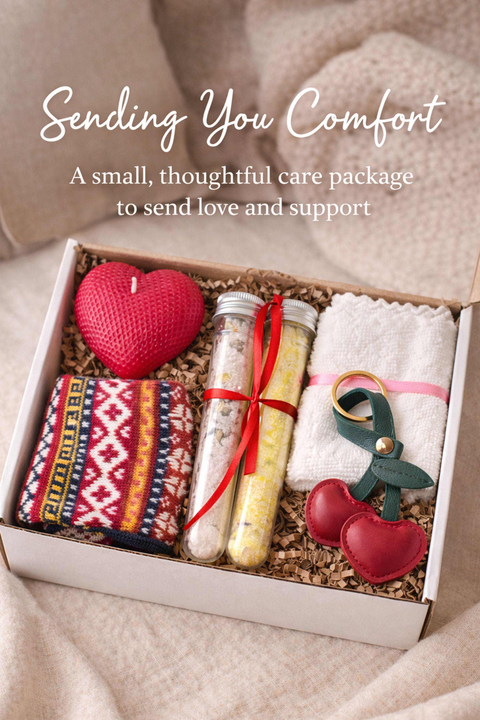 Thinking of you gift box with handmade heart candle, cozy knitted socks, bath salt tubes tied with red ribbon, soft cotton washcloth, and leather heart keychain arranged inside a kraft gift box. Small meaningful comfort gift designed as a care package for her, perfect for sending love, warmth, and support during long distance moments, stressful times, or just because. Handmade cozy gift set ready to give.