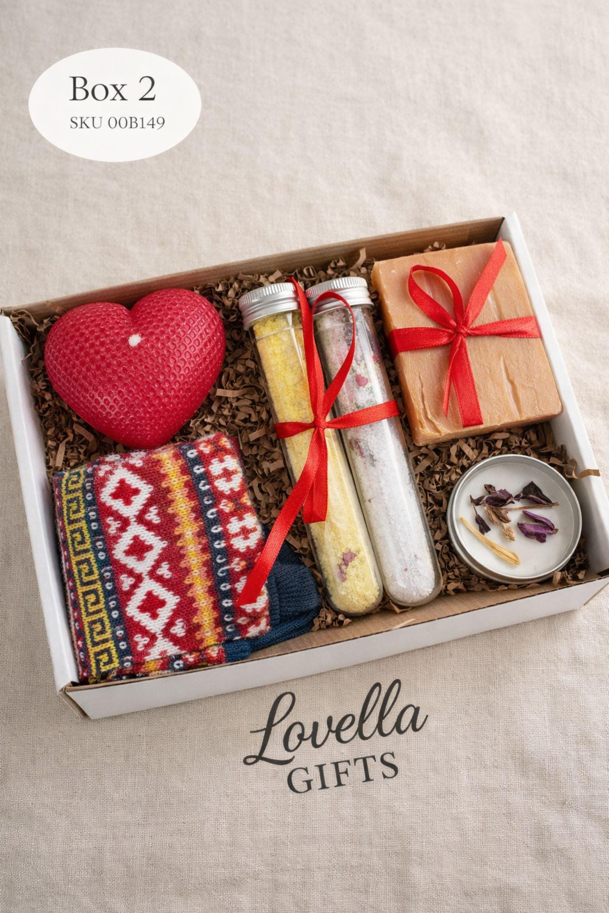 Valentines gift box shown open with a heart shaped candle, handmade soap tied with red ribbon, and two glass tubes filled with bath salts arranged inside a small kraft box. This romantic Valentine’s Day care package is designed as a cozy and thoughtful gift, perfect for surprising someone special with a handmade valentine present that feels warm, meaningful, and ready to give.