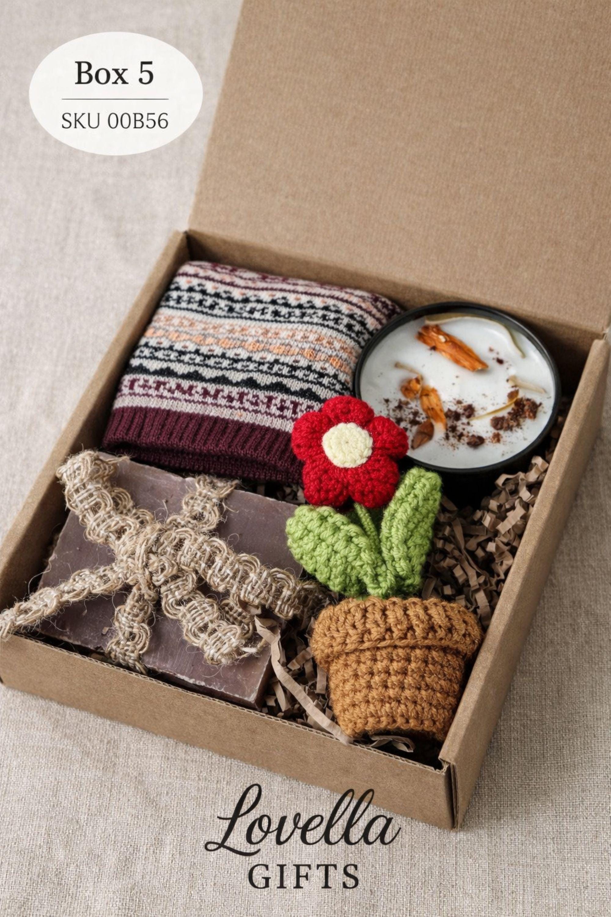 Thinking of you gift box with handmade heart candle, cozy knitted socks, bath salt tubes tied with red ribbon, soft cotton washcloth, and leather heart keychain arranged inside a kraft gift box. Small meaningful comfort gift designed as a care package for her, perfect for sending love, warmth, and support during long distance moments, stressful times, or just because. Handmade cozy gift set ready to give.