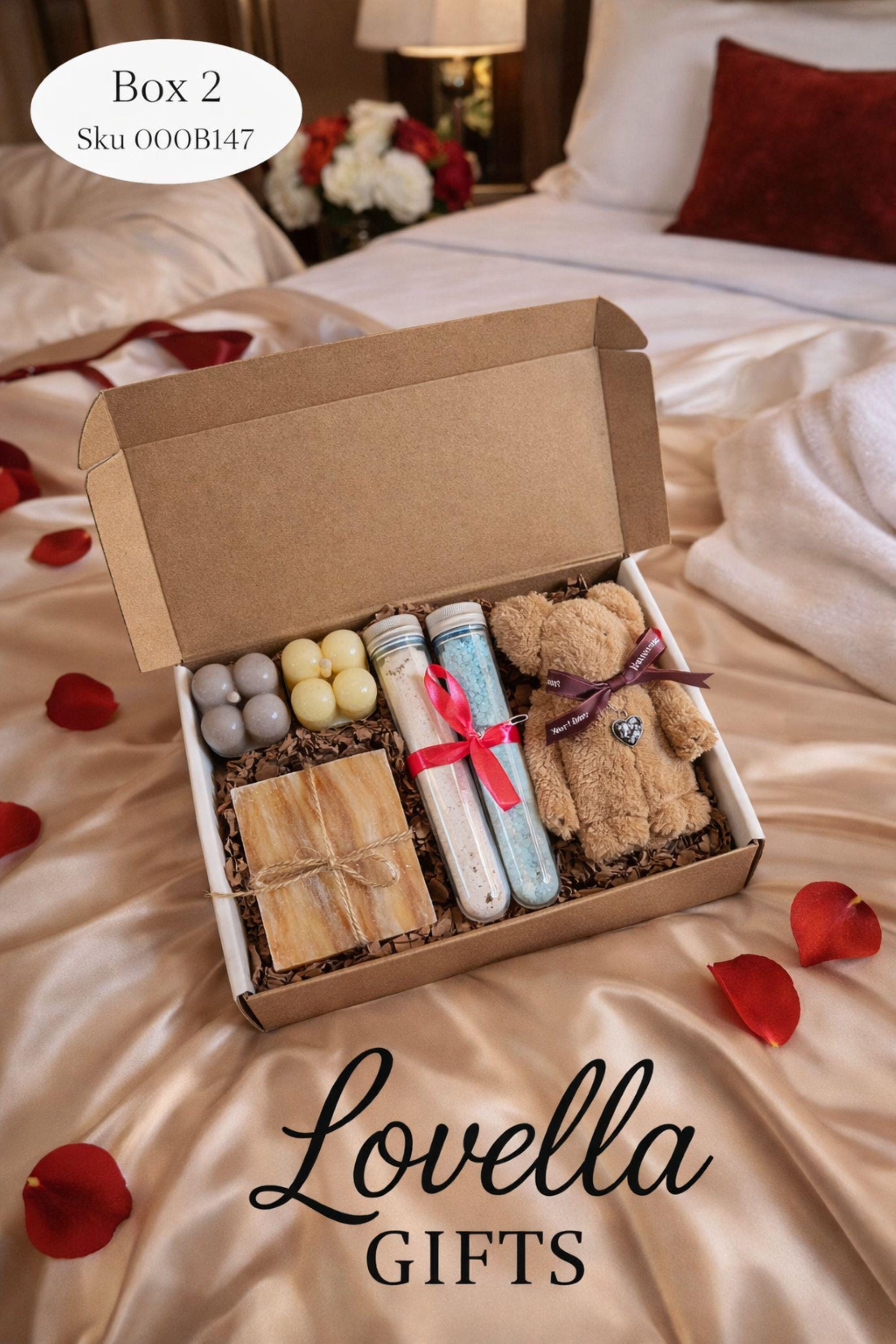 Cozy Valentine gift box with handmade soap tied with red ribbon, heart shaped candle, scented candle with dried flowers, bath salts in glass tubes, and knitted washcloth arranged in kraft gift box. Romantic self care gift for her, comfort care package, handmade Valentine’s Day gift, thinking of you box, ready to gift cozy relaxation set.