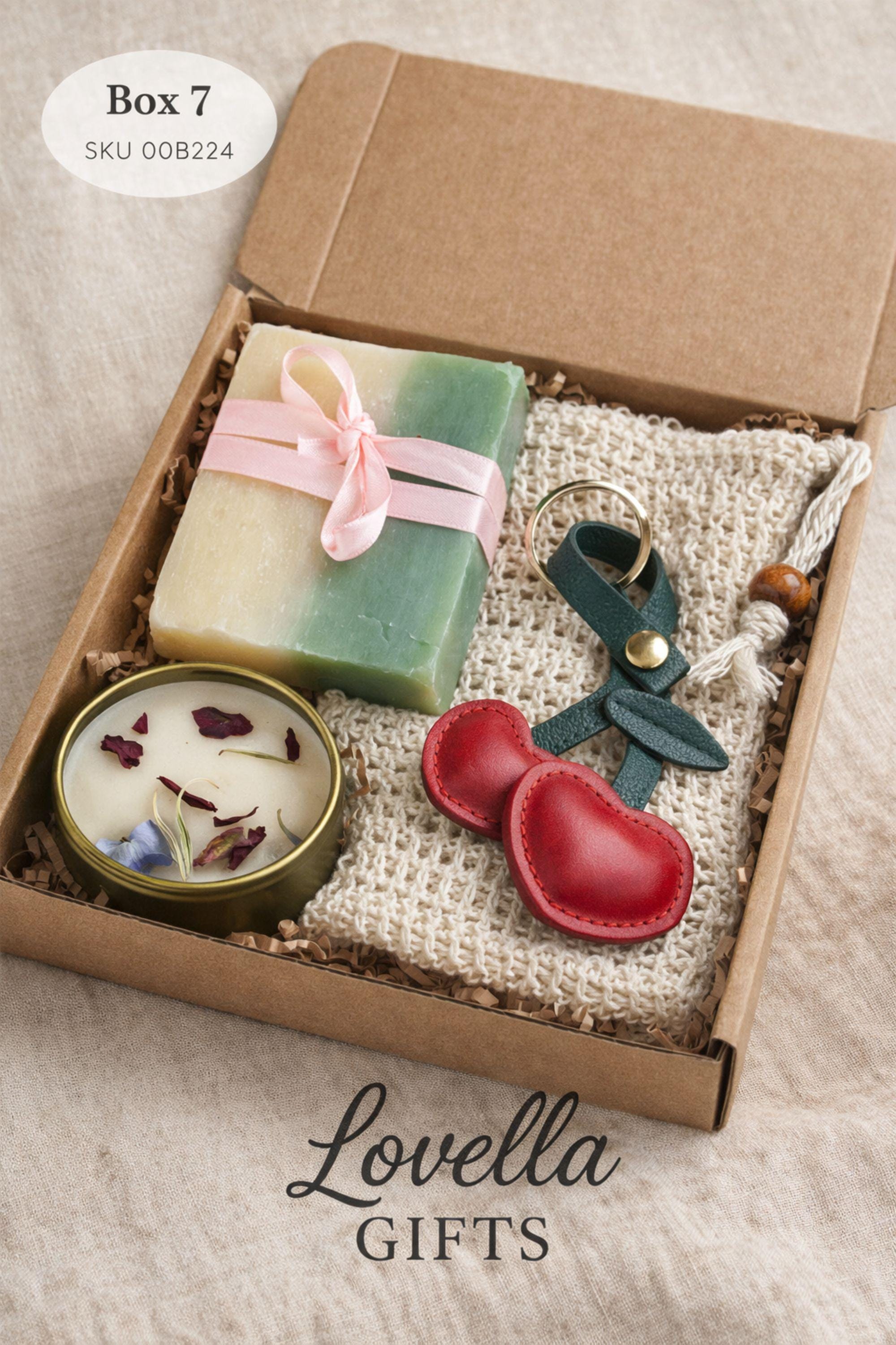 Thinking of you gift box with handmade heart candle, cozy knitted socks, bath salt tubes tied with red ribbon, soft cotton washcloth, and leather heart keychain arranged inside a kraft gift box. Small meaningful comfort gift designed as a care package for her, perfect for sending love, warmth, and support during long distance moments, stressful times, or just because. Handmade cozy gift set ready to give.