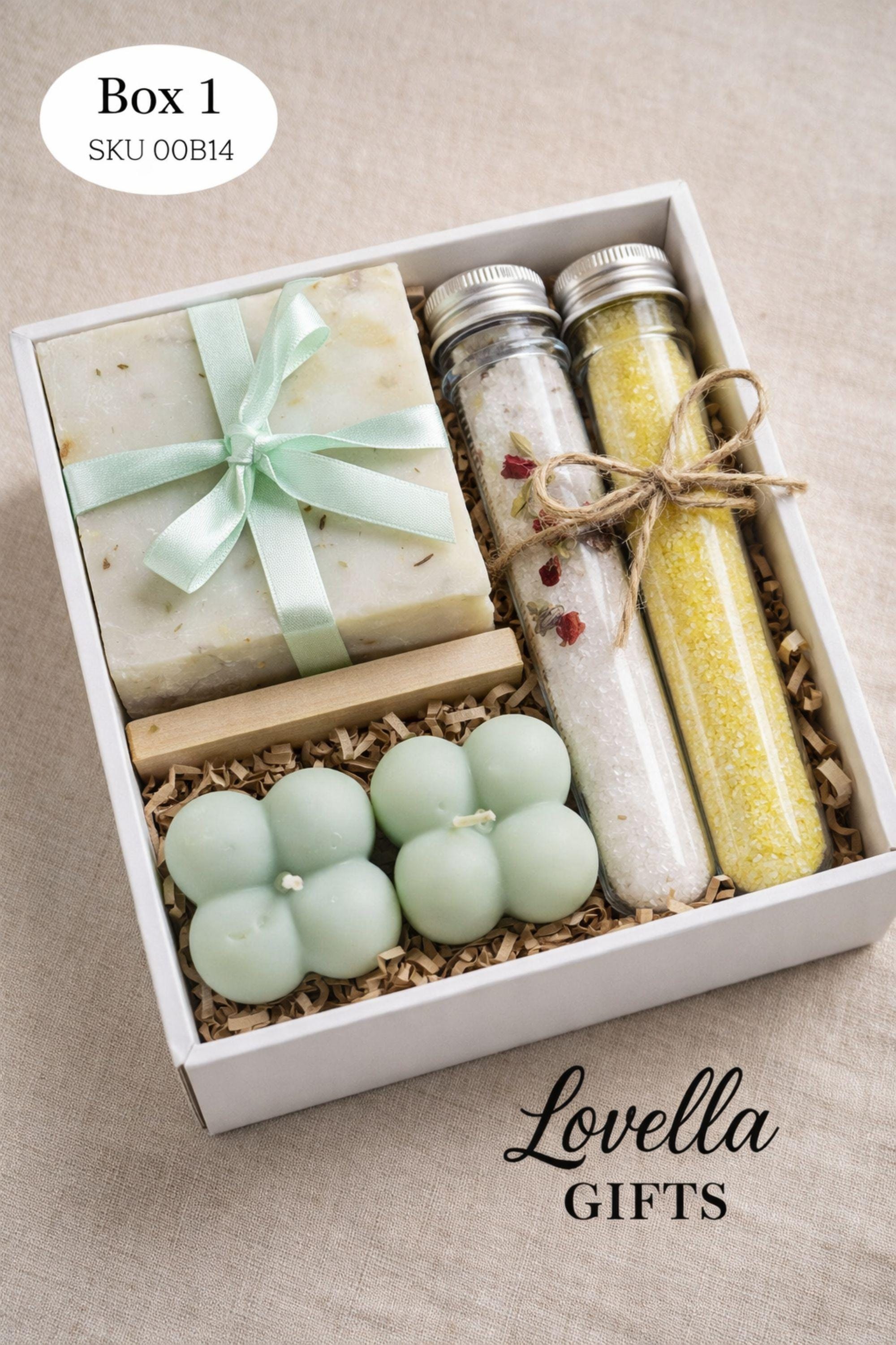 Open minimalist gift box styled in a serene home environment with neutral tones, featuring handmade sage candles, soap, and bath salts. Cozy home gift set designed for everyday calm, slow living, and simple self care routines, offering a peaceful handmade candle and soap set that fits naturally into a minimalist interior.
