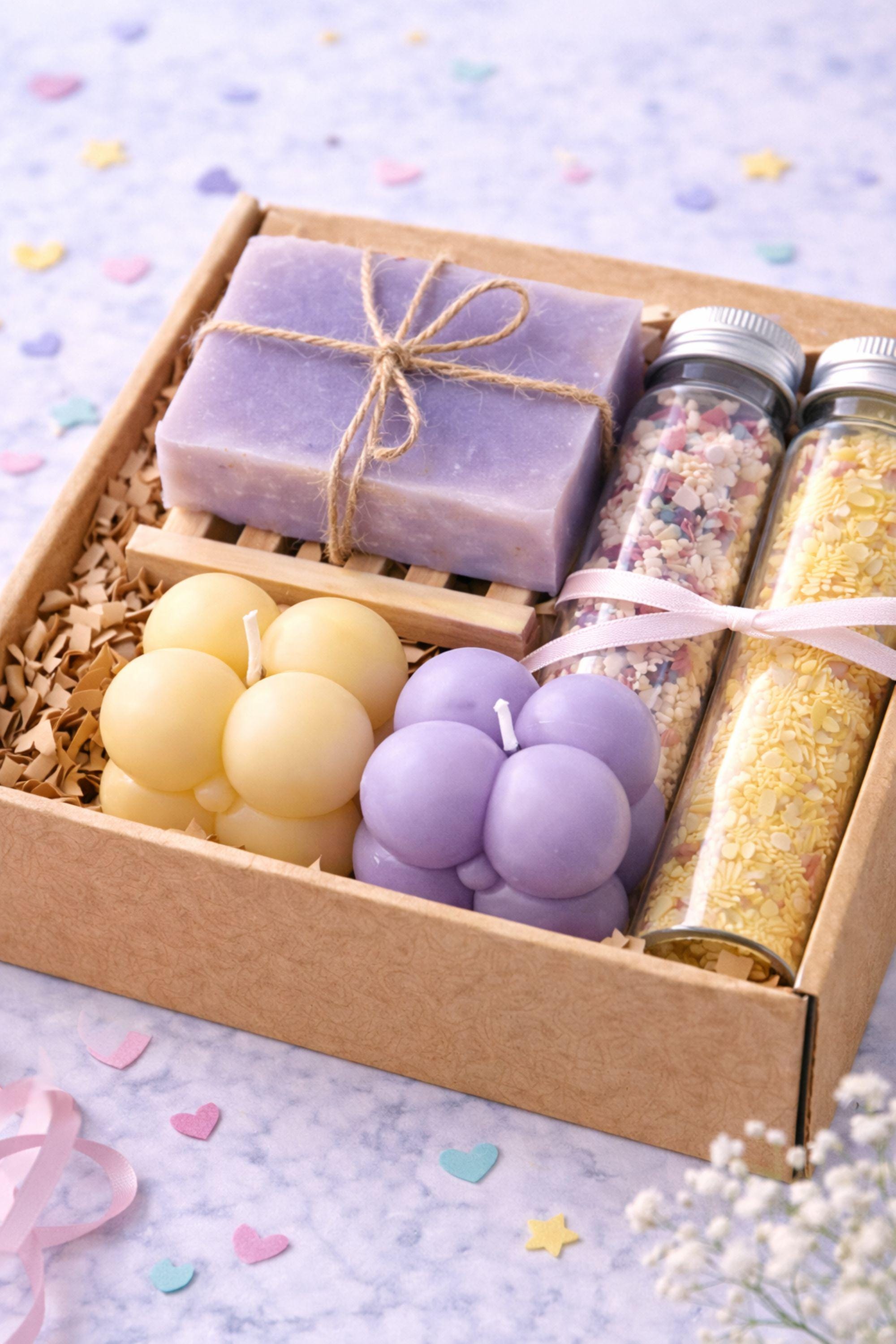 Open handmade gift box for best friend displayed on a bright, clean background, featuring colorful bubble candles, natural soap tied with twine, and two glass tubes of bath salts arranged neatly inside a small 6x6 inch kraft box. Cheerful gift for best friend designed as a fun and cozy handmade present, perfect for birthdays, celebrations, or everyday surprises.