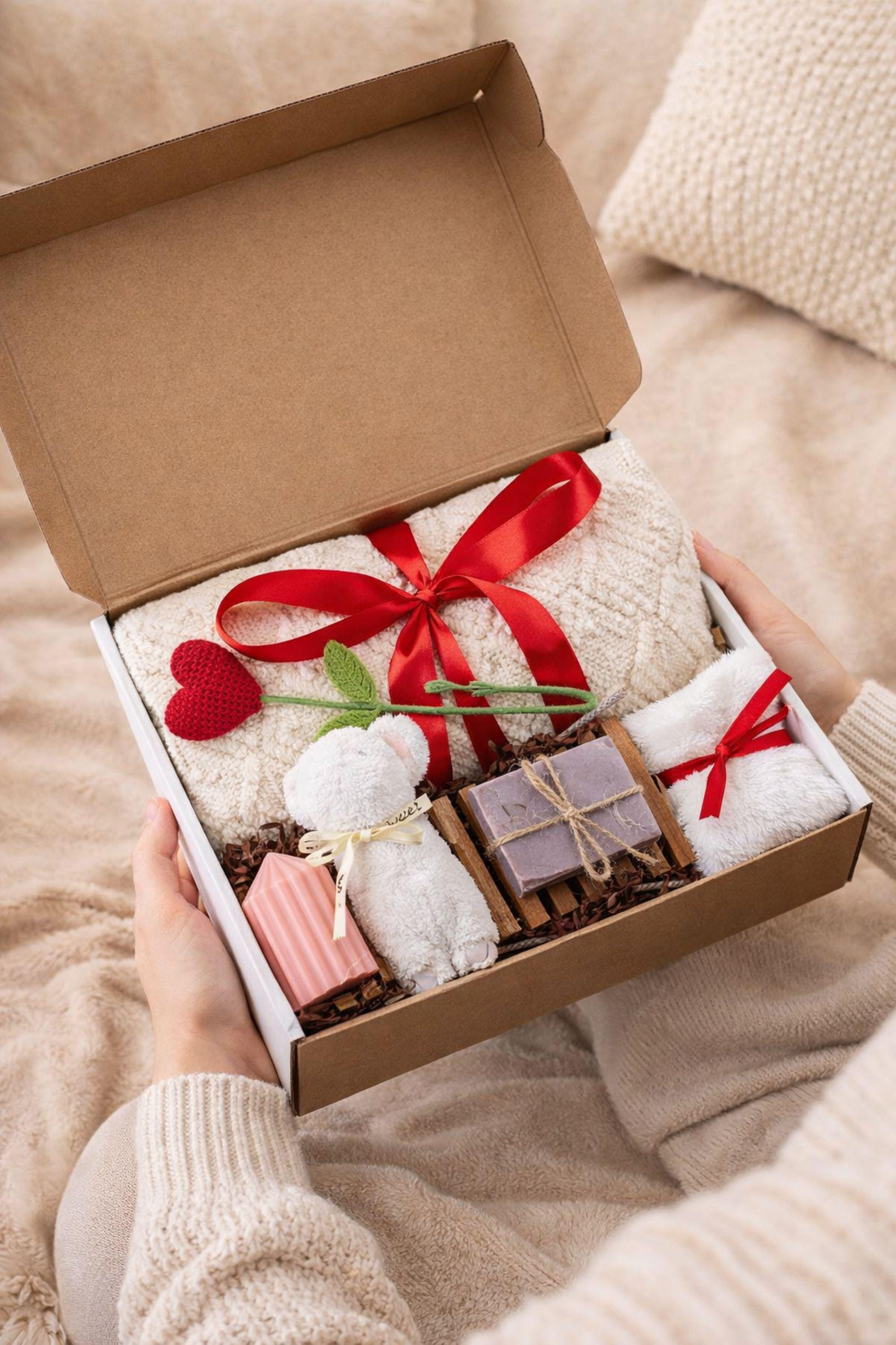 Valentine gift box with soft cozy blanket, candle, handmade soap, plush comfort items, and romantic heart details arranged in a gift-ready box. This cozy romantic Valentine care package is designed to send love, warmth, and comfort, perfect for long distance Valentine gifting, self love moments, or a thoughtful romantic surprise for her.