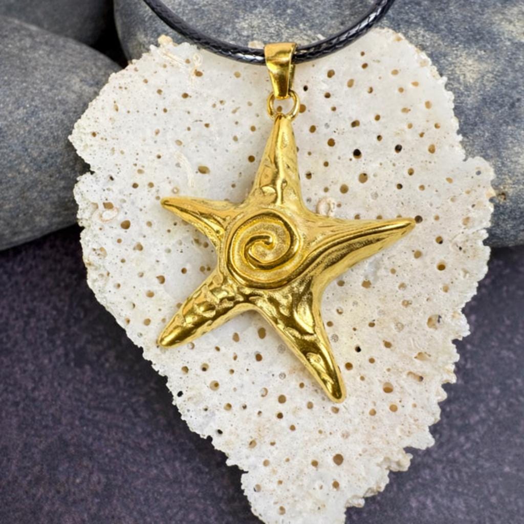 Coastal Star Necklace on a black cord displayed over a white coral texture.