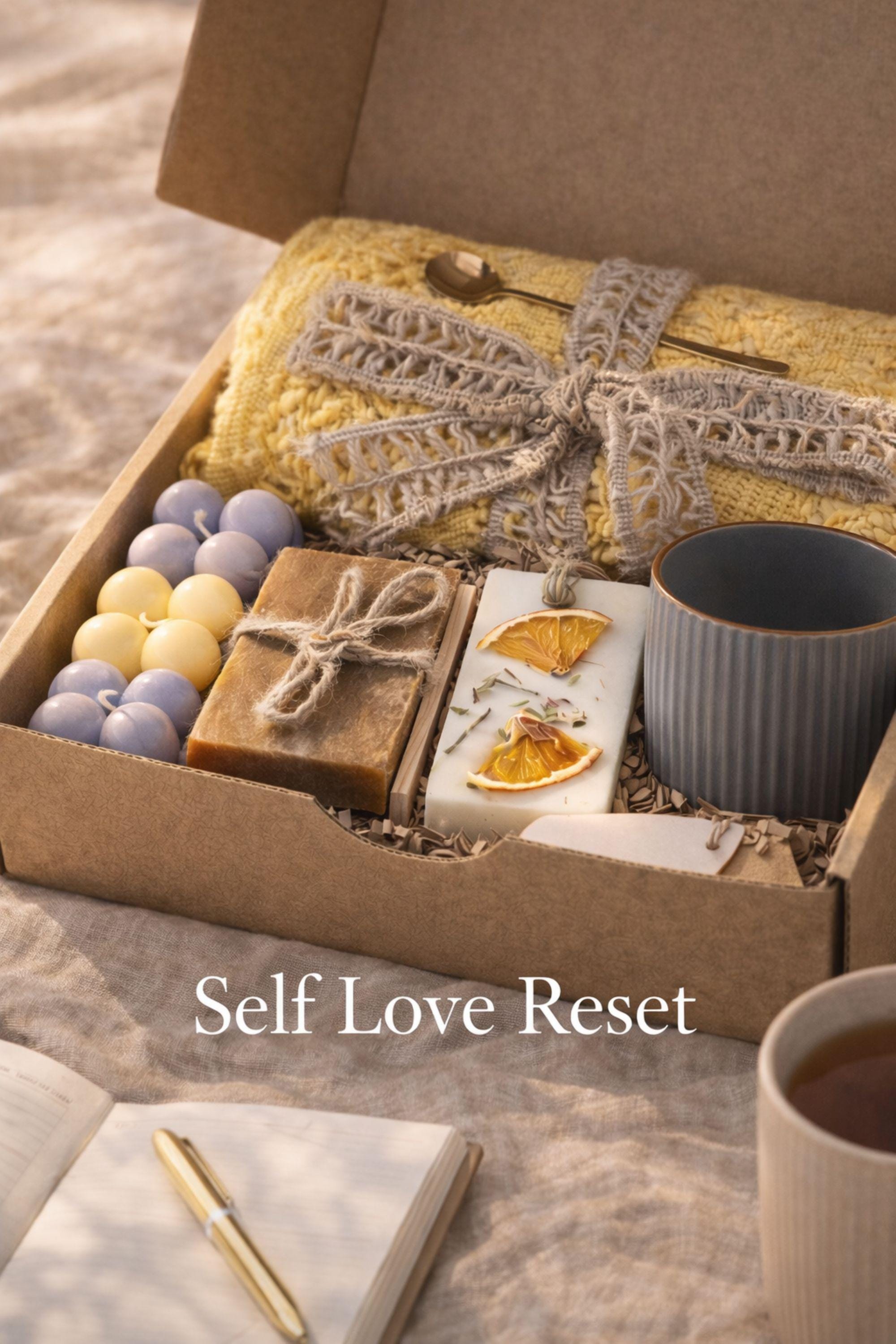 Self Love Reset gift box for women displayed on warm neutral linen background with soft window light, featuring yellow knit blanket, handmade natural soap, pastel bubble candles, citrus wax tablet with dried orange slices, ceramic mug and wooden soap dish. Emotional healing care package for new beginnings, self care gift for her, breakup recovery support box, thoughtful reset present.