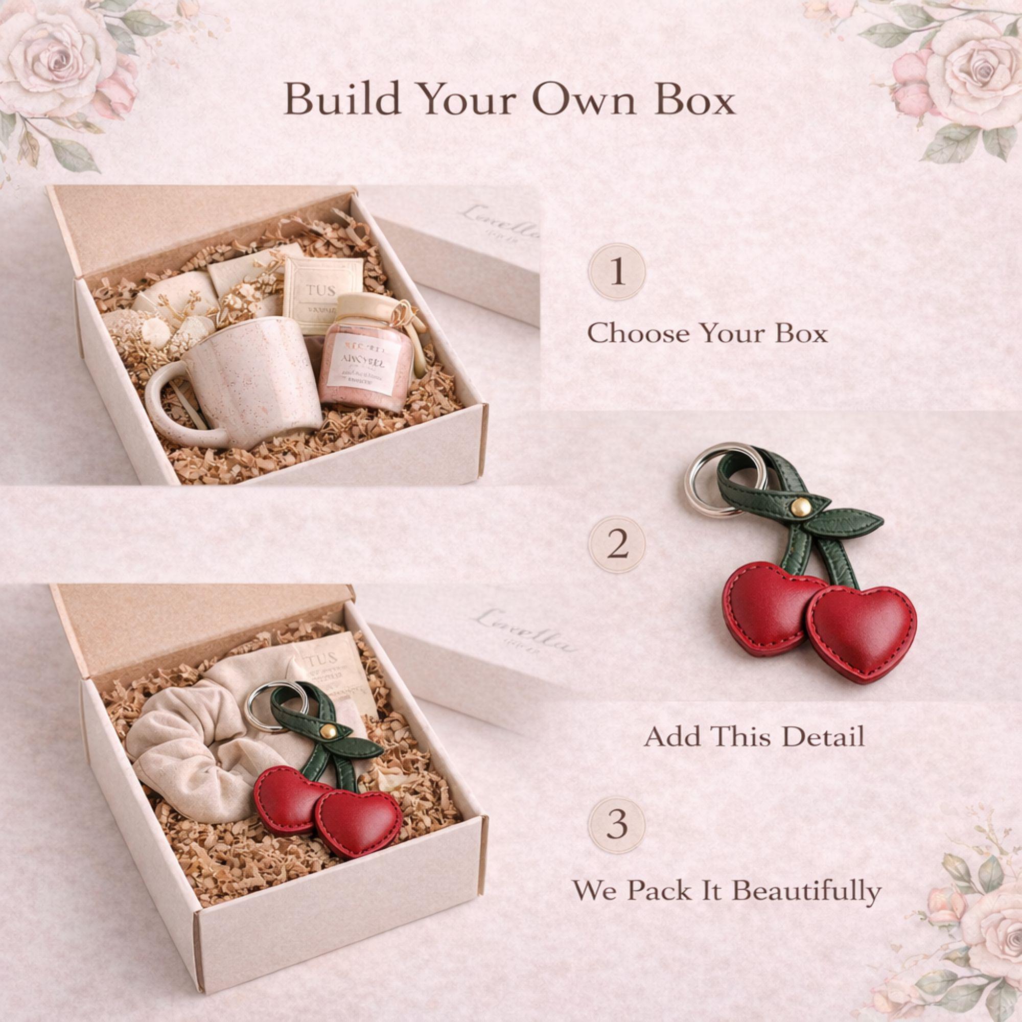 Red cherry keychain add on displayed on neutral floral background. Faux leather bag charm with green stem and silver ring styled as gift box upgrade. Cute aesthetic accessory for build your own gift box, birthday gift, Valentine care package, or cozy self care set.