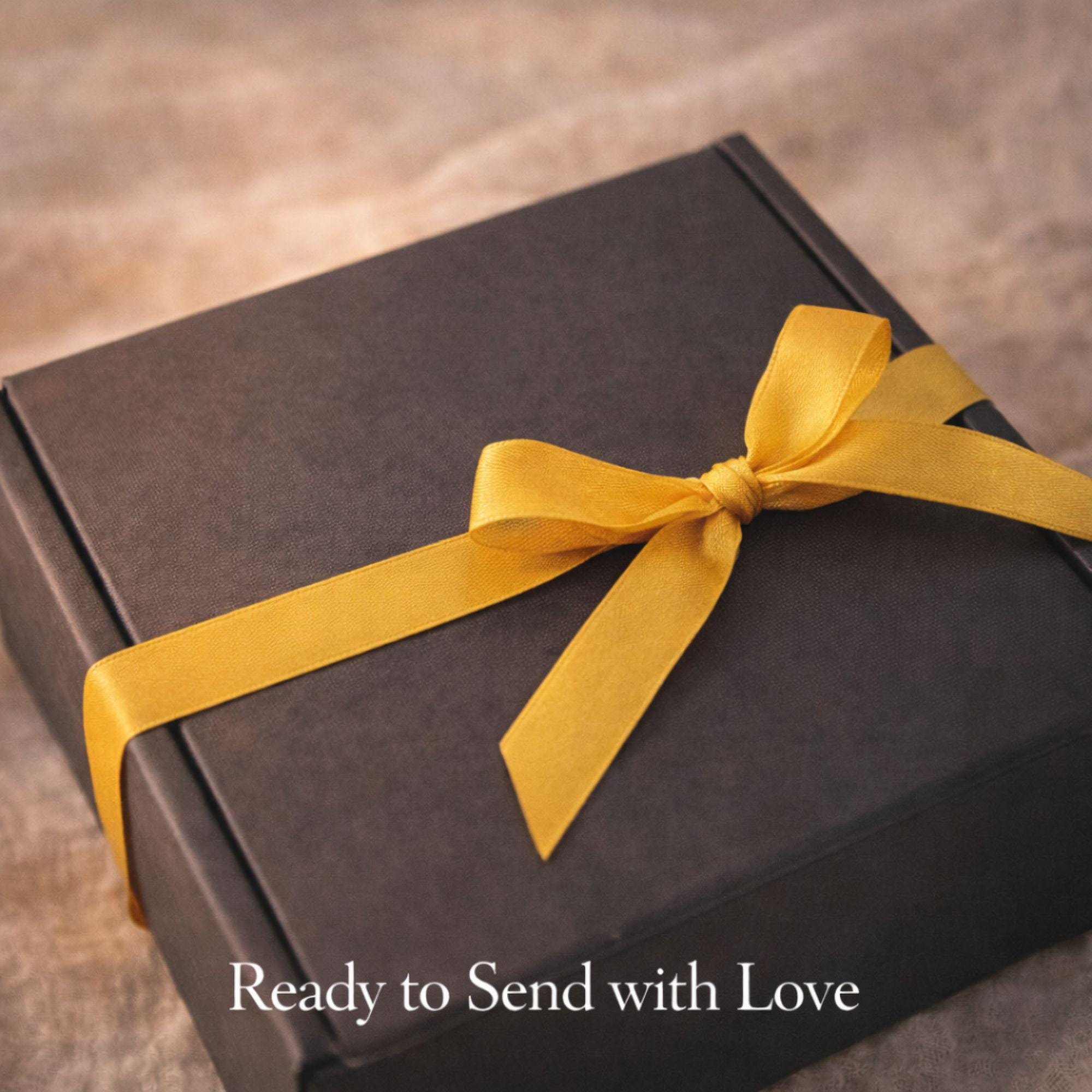 Pet loss sympathy gift box with memorial candle, honey soap, dried flowers, bath salts and matches arranged in elegant black gift box. Comfort care package designed as dog or cat memorial gift for grieving pet owner. Thoughtful pet bereavement gift with remembrance candle and self care elements to offer support after the loss of a beloved pet.