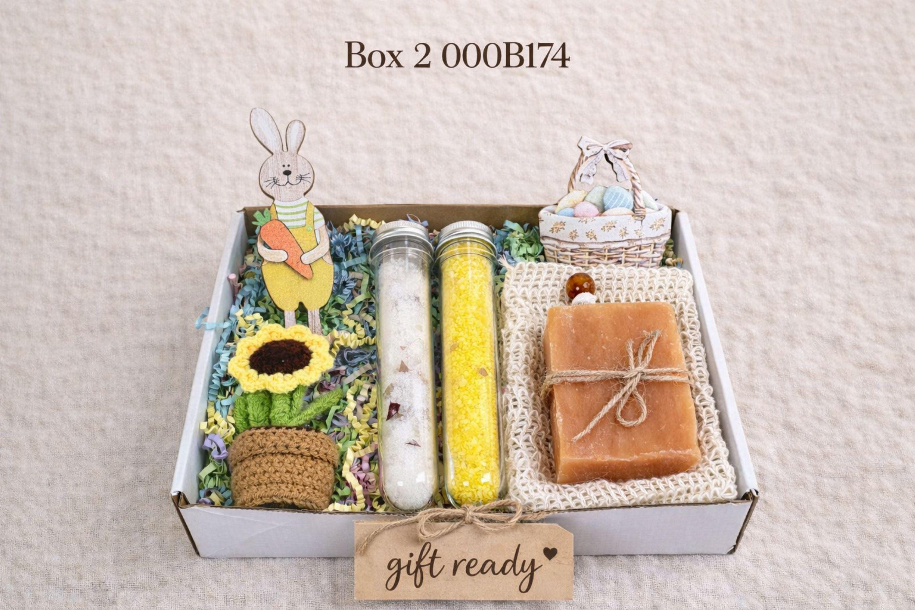 small easter gift box with wooden bunny decoration, crochet sunflower in pot, handmade botanical wax sachet, mini easter basket with eggs, soft neutral cloth wrapped with twine, colorful paper filler, spring themed gift box for women, ready to gift easter care package, cozy handmade spring gift set, pastel aesthetic small gift box