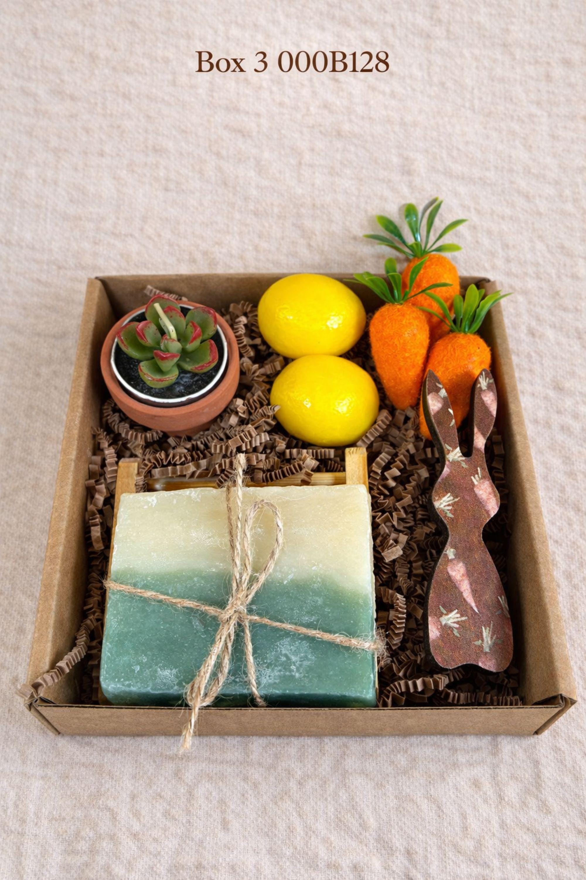 small easter gift box with wooden bunny decoration, crochet sunflower in pot, handmade botanical wax sachet, mini easter basket with eggs, soft neutral cloth wrapped with twine, colorful paper filler, spring themed gift box for women, ready to gift easter care package, cozy handmade spring gift set, pastel aesthetic small gift box