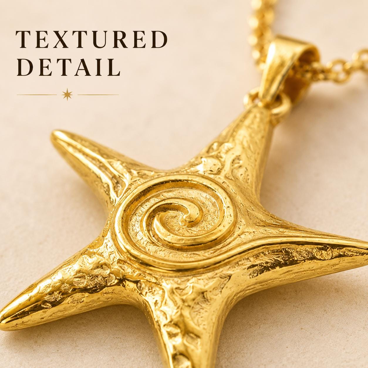 Gold star necklace with textured starfish pendant and raised spiral center, shown in a macro close-up view highlighting intricate artisan details, polished gold finish, and sculptural coastal design.