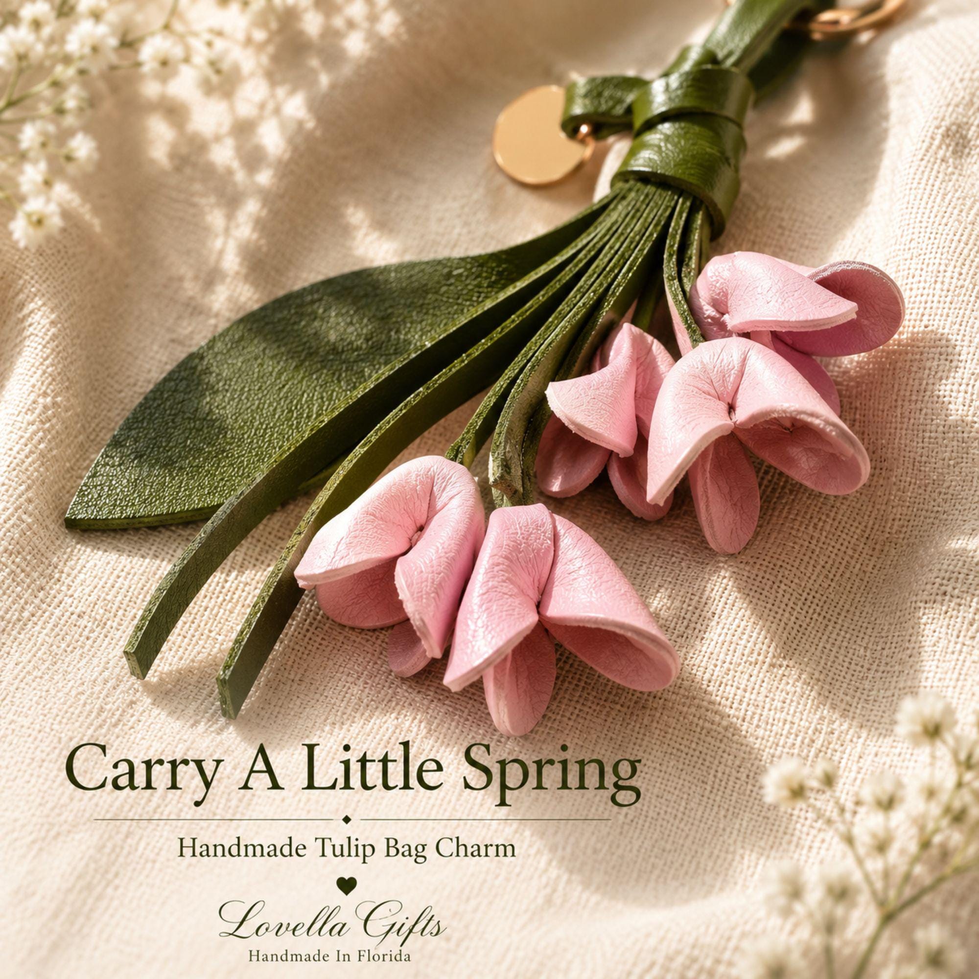 Handmade leather tulip bag charm featuring five soft blush pink leather tulip flowers, an olive green leather leaf, handmade leather tassel, and gold hardware. Floral purse charm designed for tote bags, handbags, shoulder bags, backpacks, straw bags, beach bags, and everyday purses. Lightweight botanical leather keychain inspired by spring flowers. A thoughtful handmade gift for women, moms, sisters, daughters, bridesmaids, birthdays, Mother's Day, and spring fashion lovers.