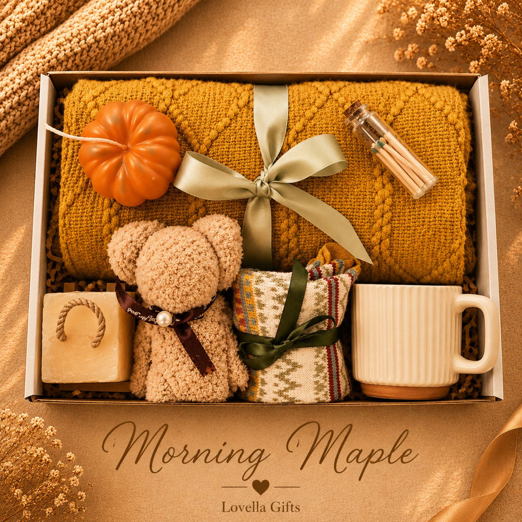 Thanksgiving gift box for women featuring a cozy knit blanket, handmade pumpkin soy candle, ceramic mug, artisan soap, decorative glass match bottle, plush teddy bear and cozy autumn socks in boutique gift packaging. Thanksgiving hostess gift basket perfect for hostess appreciation, thank you gifts, fall care packages, cozy blanket gifts, autumn self care, holiday gatherings, and seasonal gifts for mom, grandma, sister, friend, teacher or coworker.