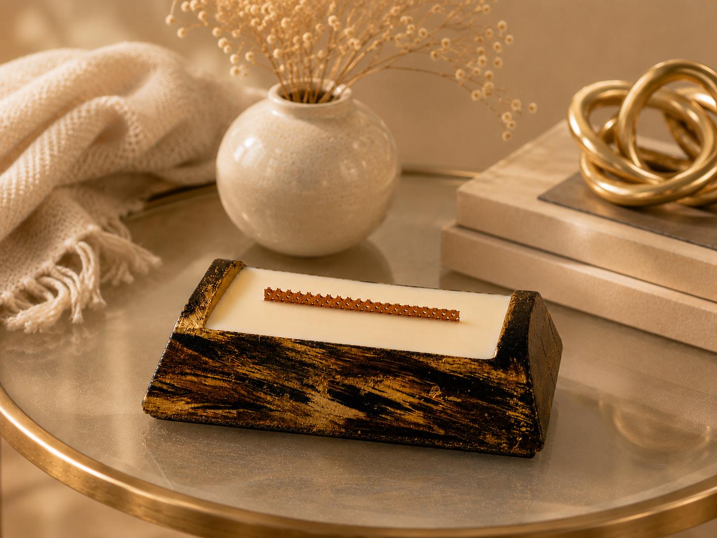 Luxury Decorative Candle - image 6 showing black gold artisan candle, ivory wax, wood wick, and elegant home decor styling. Modern Wood Wick Candle for housewarming gifts, coffee table decor, and luxury home styling.
