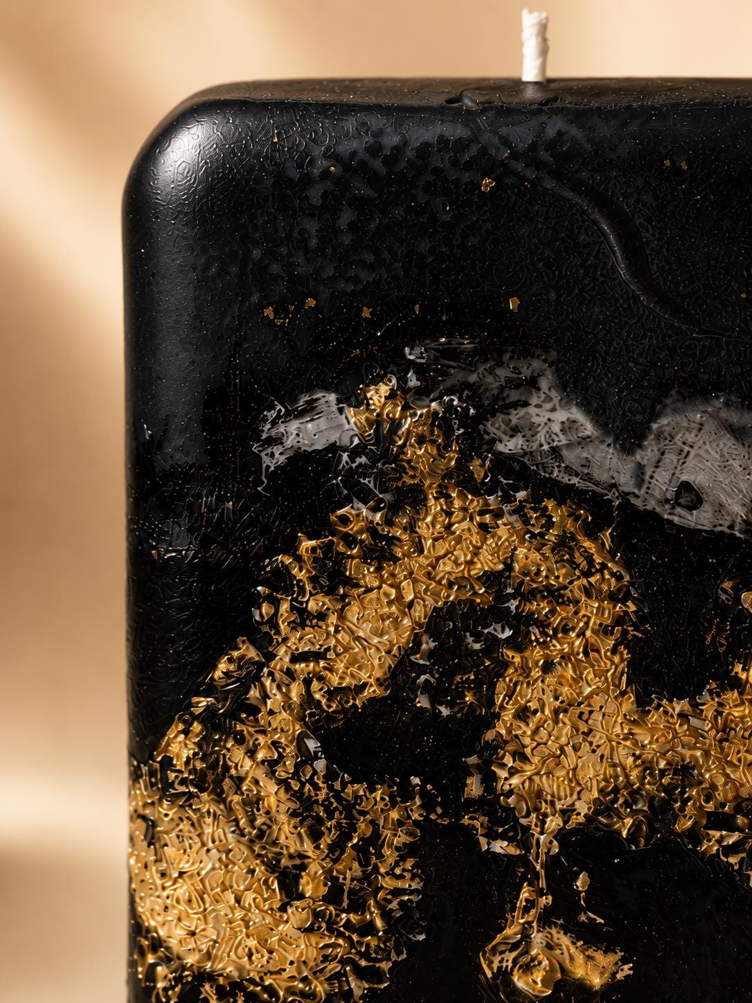 Black Gold Decorative Candle handmade luxury candle with gold leaf accents, sculptural black design, modern coffee table decor, and elegant housewarming gift styling.