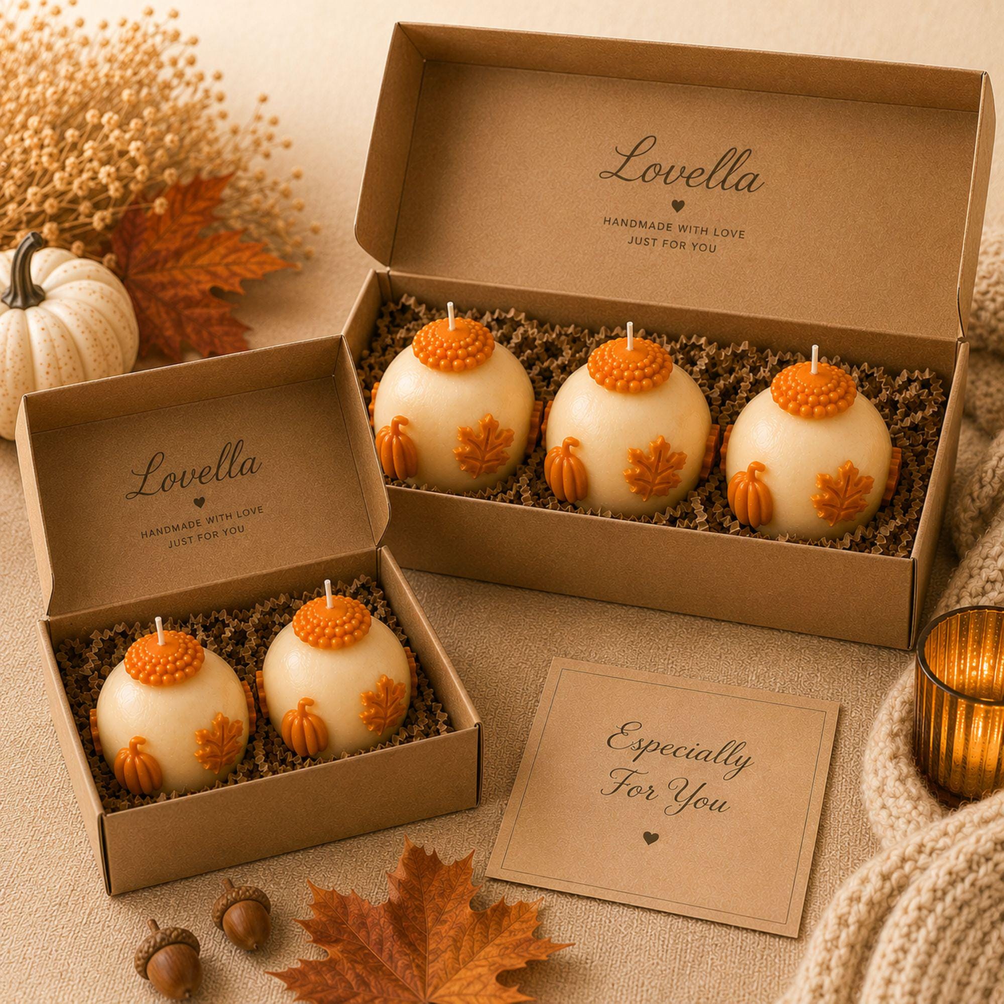 Handmade pumpkin candle set featuring ivory 3 inch sphere candles with dimensional orange pumpkins, maple leaves and autumn details, shown as a set of 2 and set of 3 in rustic kraft gift boxes. Decorative unscented fall candles for autumn home decor, Thanksgiving table decor, fall centerpiece, mantel decor, coffee table styling, farmhouse pumpkin decor, hostess gift, housewarming gift, Thanksgiving gift, fall birthday gift and unique gift for pumpkin lovers.