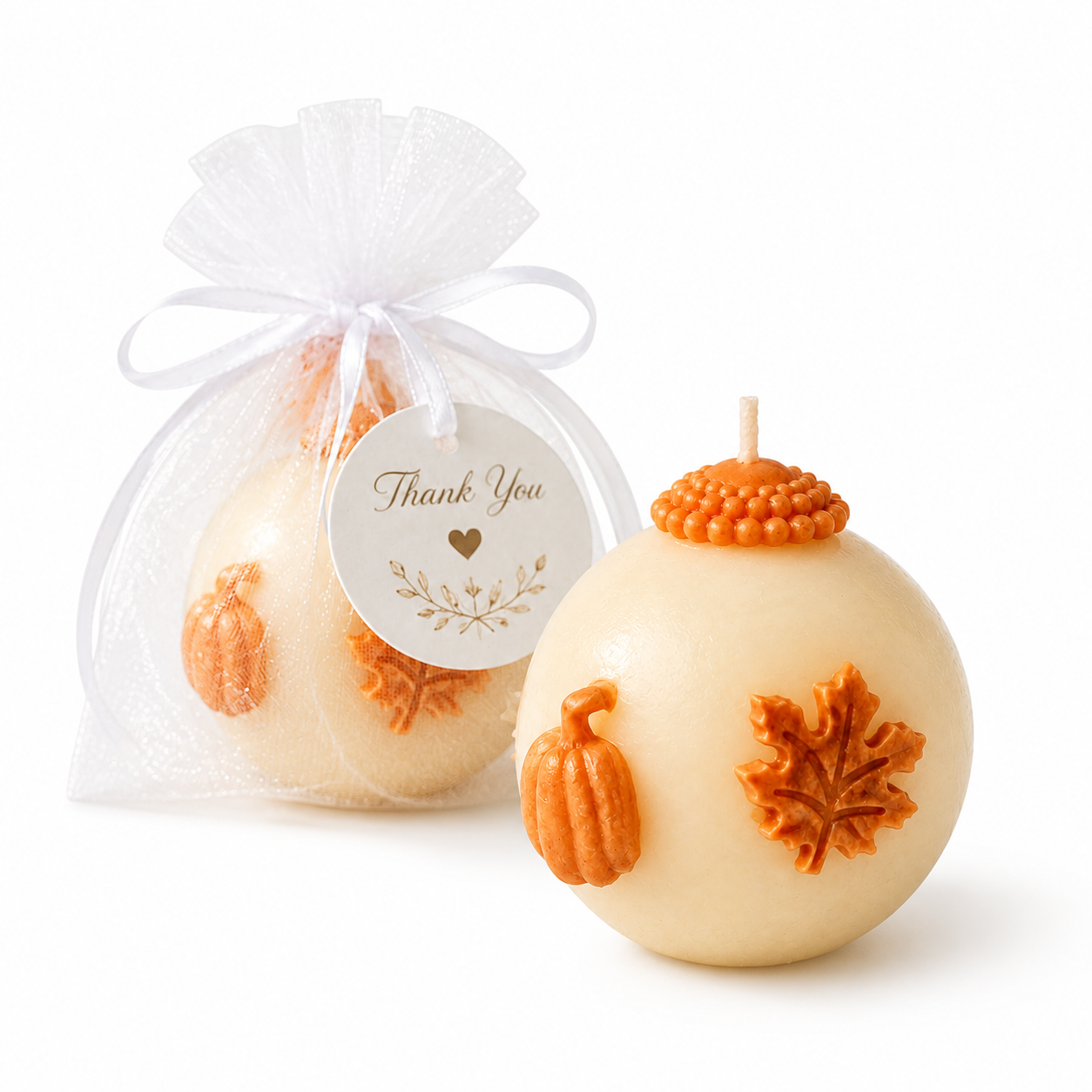 Fall wedding favor pumpkin candle with thank you tag on clean white background