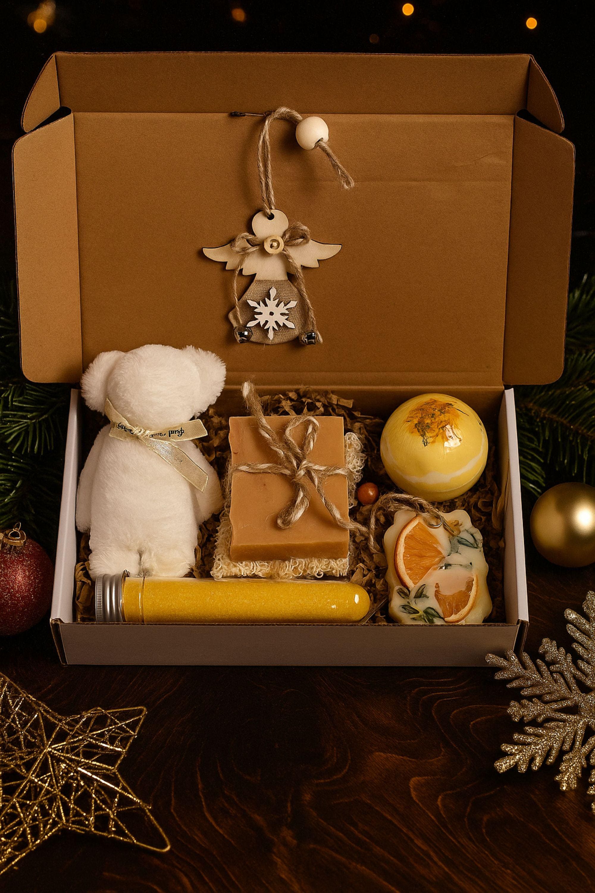 Christmas spa gift box for her with handmade soap, yellow bath bomb, citrus wax sachet, towel teddy bear, angel ornament, and aromatic bath salts. Cozy holiday self-care package for women, small Christmas gift, Secret Santa spa set, relaxation and pampering box for winter stress relief.