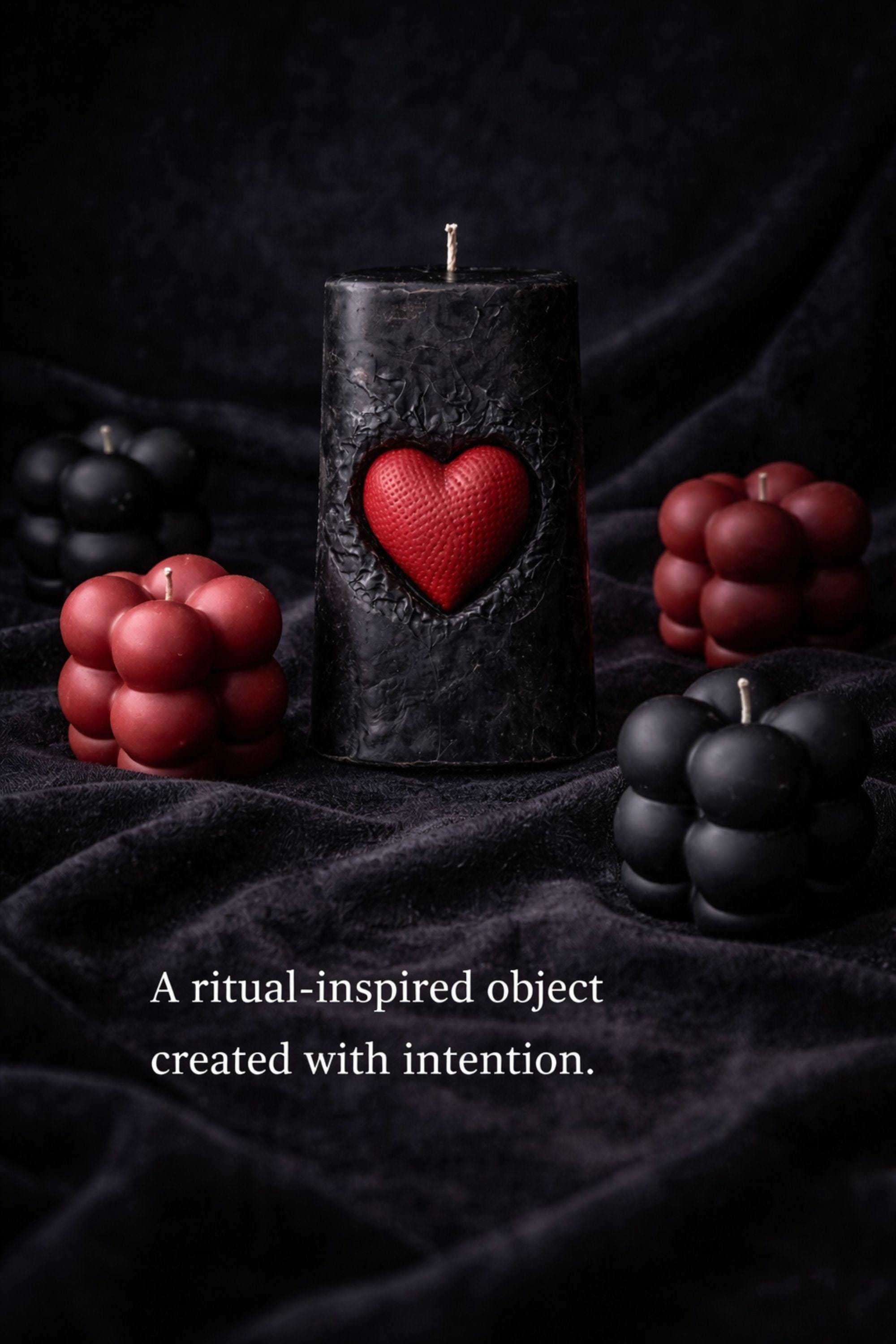 Gothic Sacred Heart Ritual Box featuring a handcrafted black candle with a red heart centerpiece and black and red bubble candles arranged in a dark gift box. This dark ritual candle set is designed for gothic home decor, witchy interiors, and alternative spiritual gifts. Unique handmade candle box with dramatic dark aesthetic, perfect for altar decor, shelves, or intentional spaces.