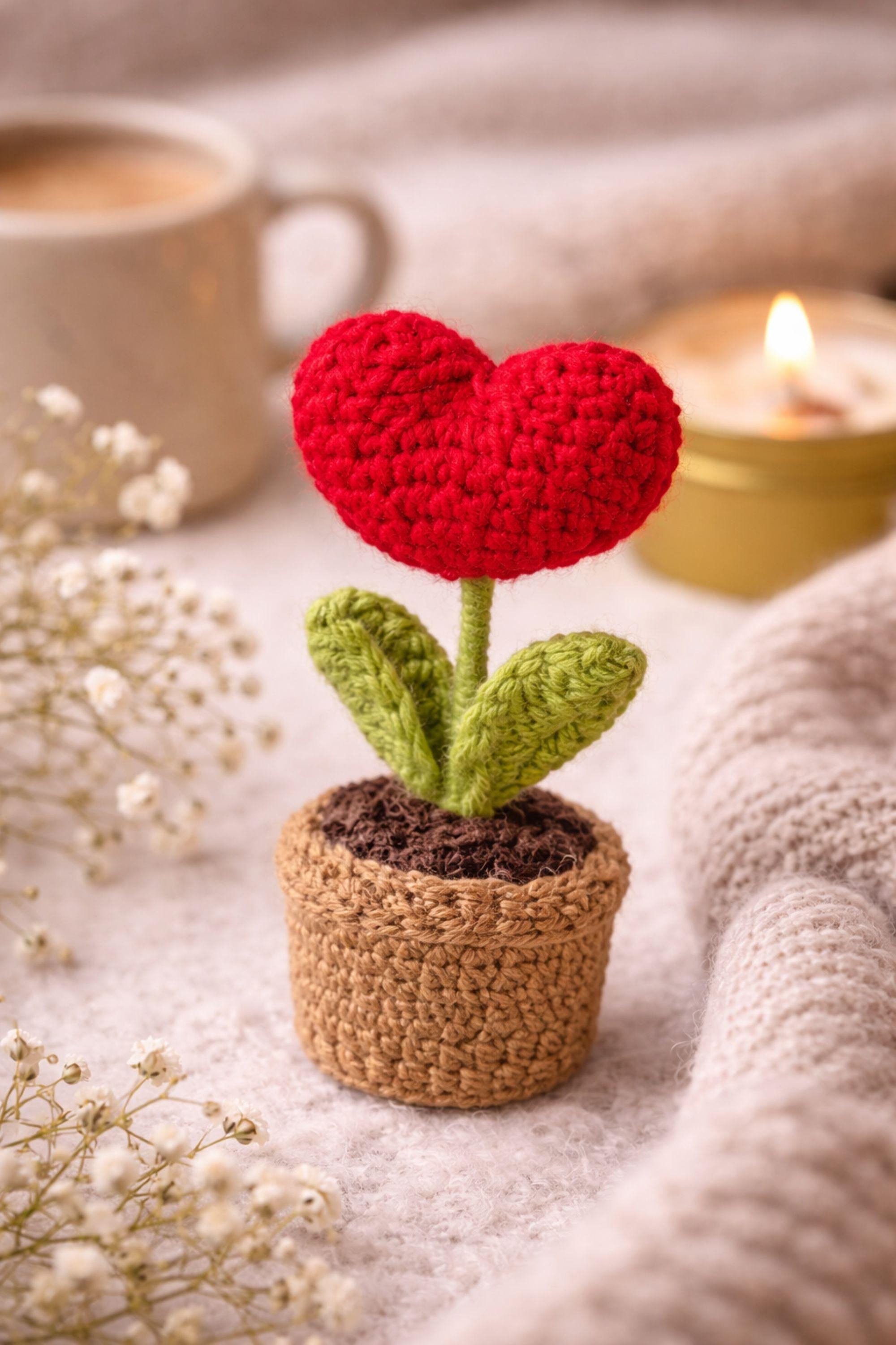 Handmade crochet flower gift box with crochet flower in a pot, handmade soap, botanical candle in a tin, and two bath salt tubes arranged in a black gift box. Thoughtful comfort gift designed to show care and appreciation. Perfect thinking of you gift, friendship gift, or unique handmade present for her, beautifully packaged and ready to give.