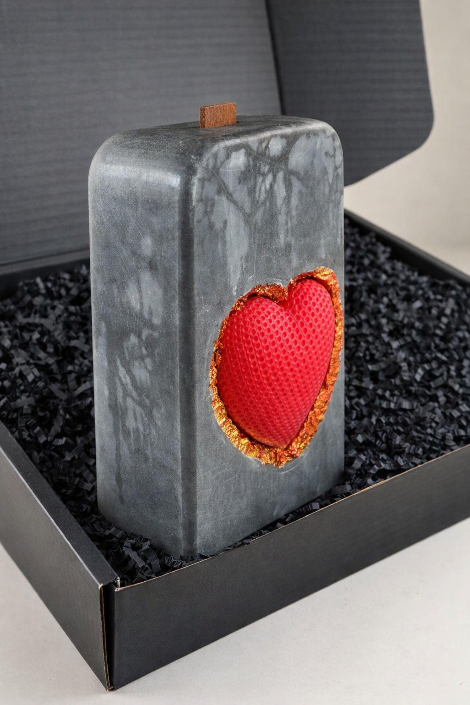 Luxury grey statement candle with a red textured heart framed in gold, handcrafted designer candle created as a romantic gift and modern decor object. This luxury heart candle is designed as a meaningful anniversary or Valentine’s gift for her, combining sculptural form, stone-inspired texture, and gold detail for a centerpiece candle look.