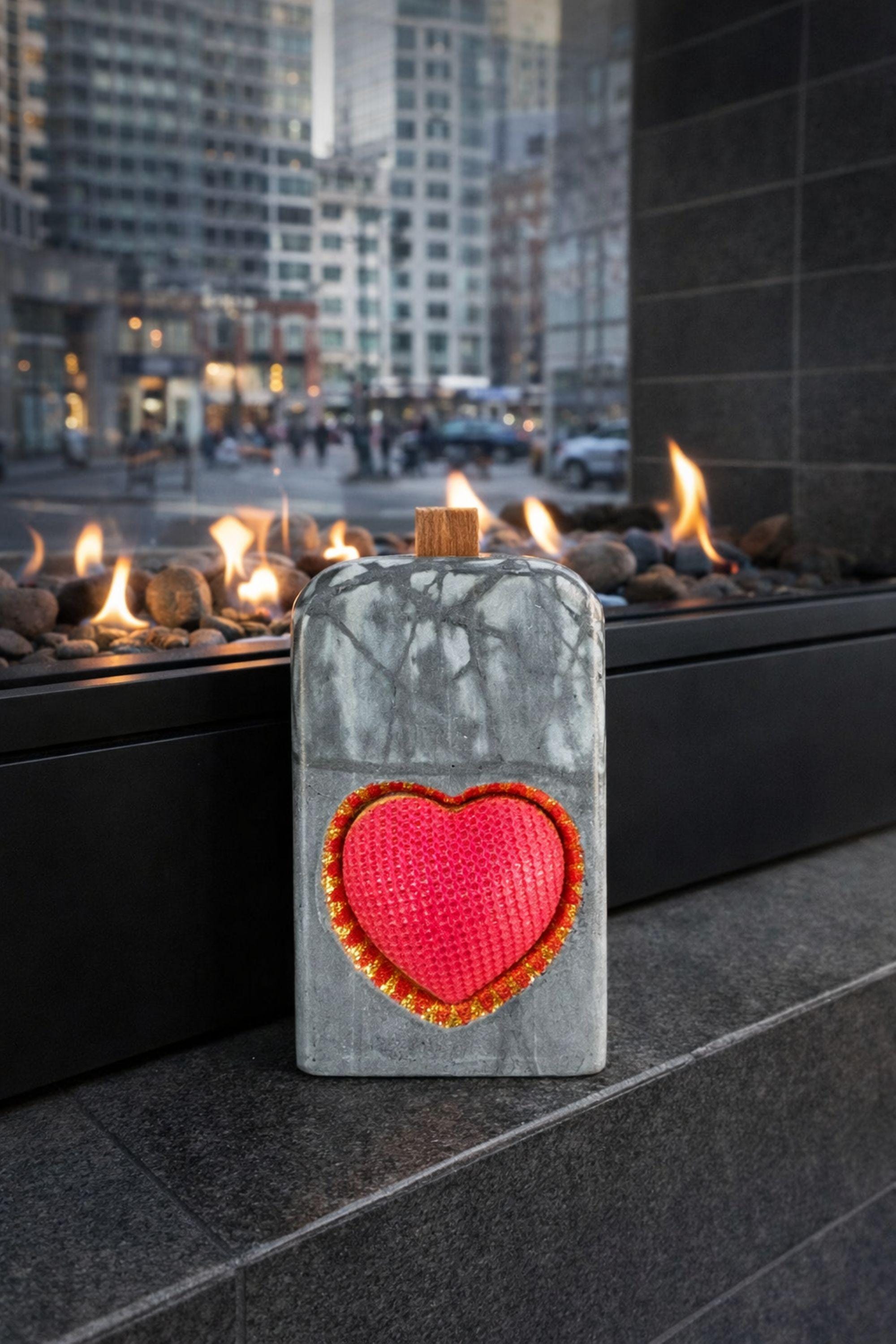 Luxury grey statement candle with a red textured heart framed in gold, handcrafted designer candle created as a romantic gift and modern decor object. This luxury heart candle is designed as a meaningful anniversary or Valentine’s gift for her, combining sculptural form, stone-inspired texture, and gold detail for a centerpiece candle look.