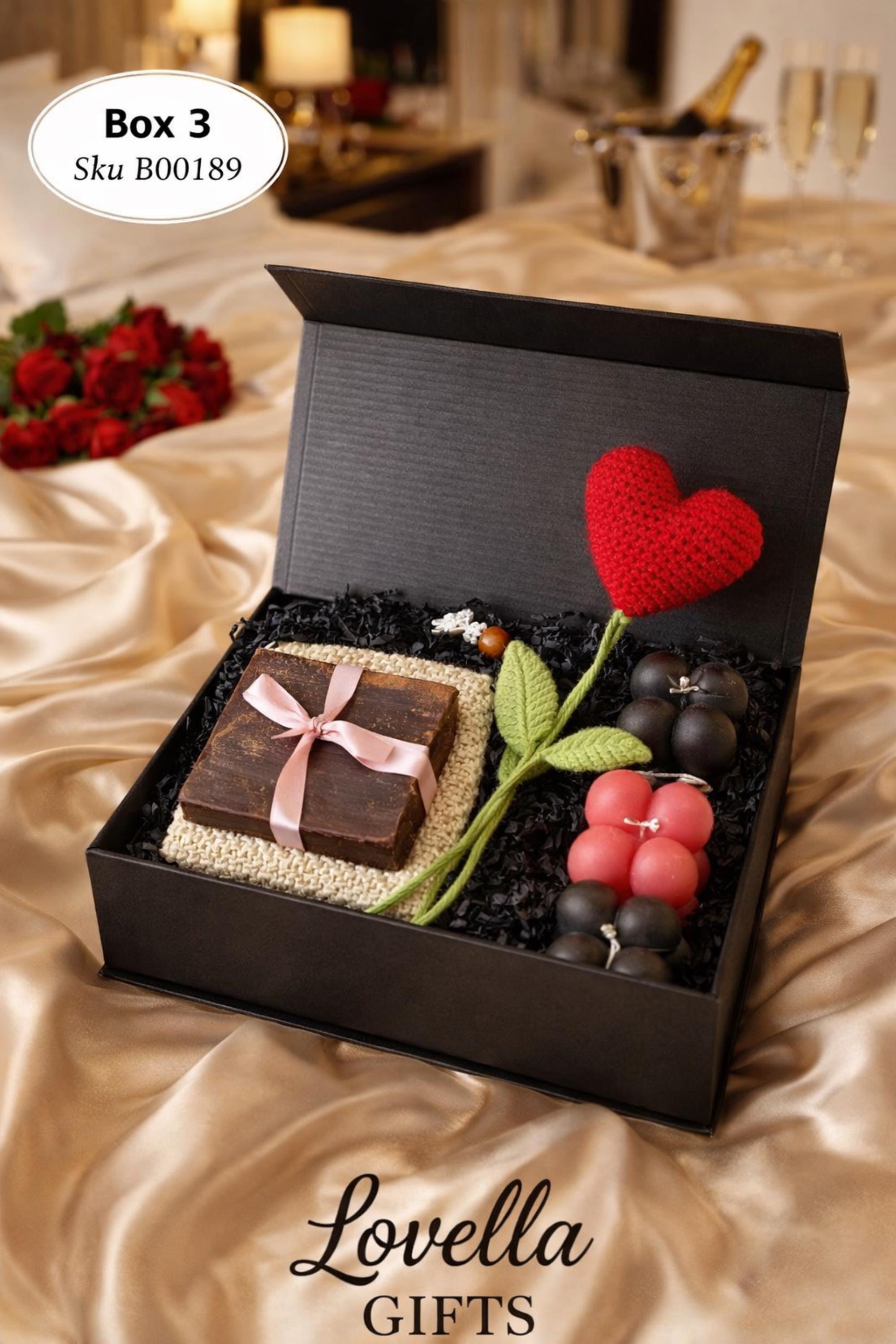 Cozy Valentine gift box with handmade soap tied with red ribbon, heart shaped candle, scented candle with dried flowers, bath salts in glass tubes, and knitted washcloth arranged in kraft gift box. Romantic self care gift for her, comfort care package, handmade Valentine’s Day gift, thinking of you box, ready to gift cozy relaxation set.
