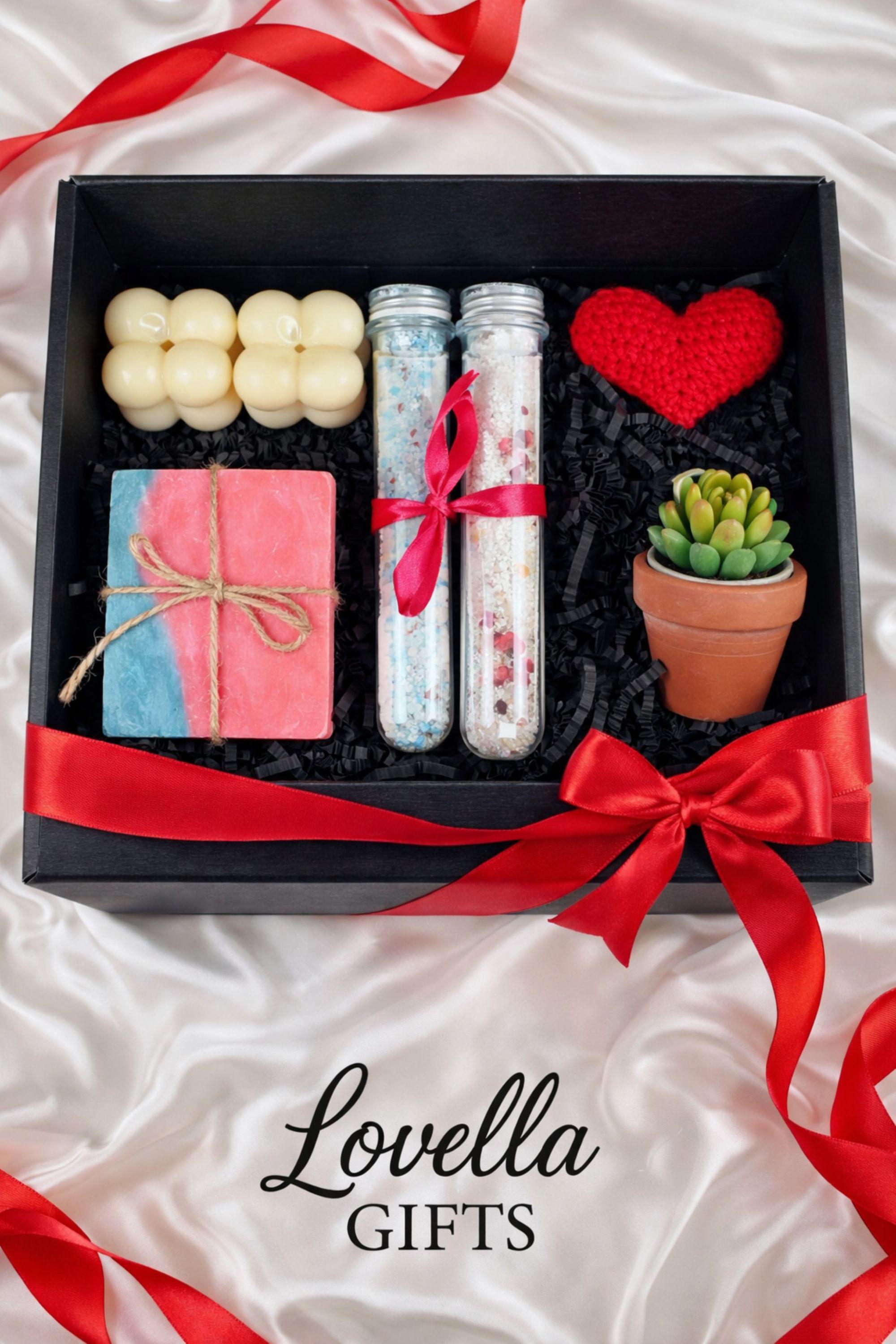 Self love Valentine spa gift box featuring two handmade bubble candles, artisan soap tied with twine, bath salts in glass tubes with ribbon, a crochet heart, and a decorative succulent in a gift box with shredded paper filler. Neutral and calming self care gift for women, ready to gift for Valentine’s Day, self love, thinking of you, or just because occasions. Handmade spa gift with cozy aesthetic.