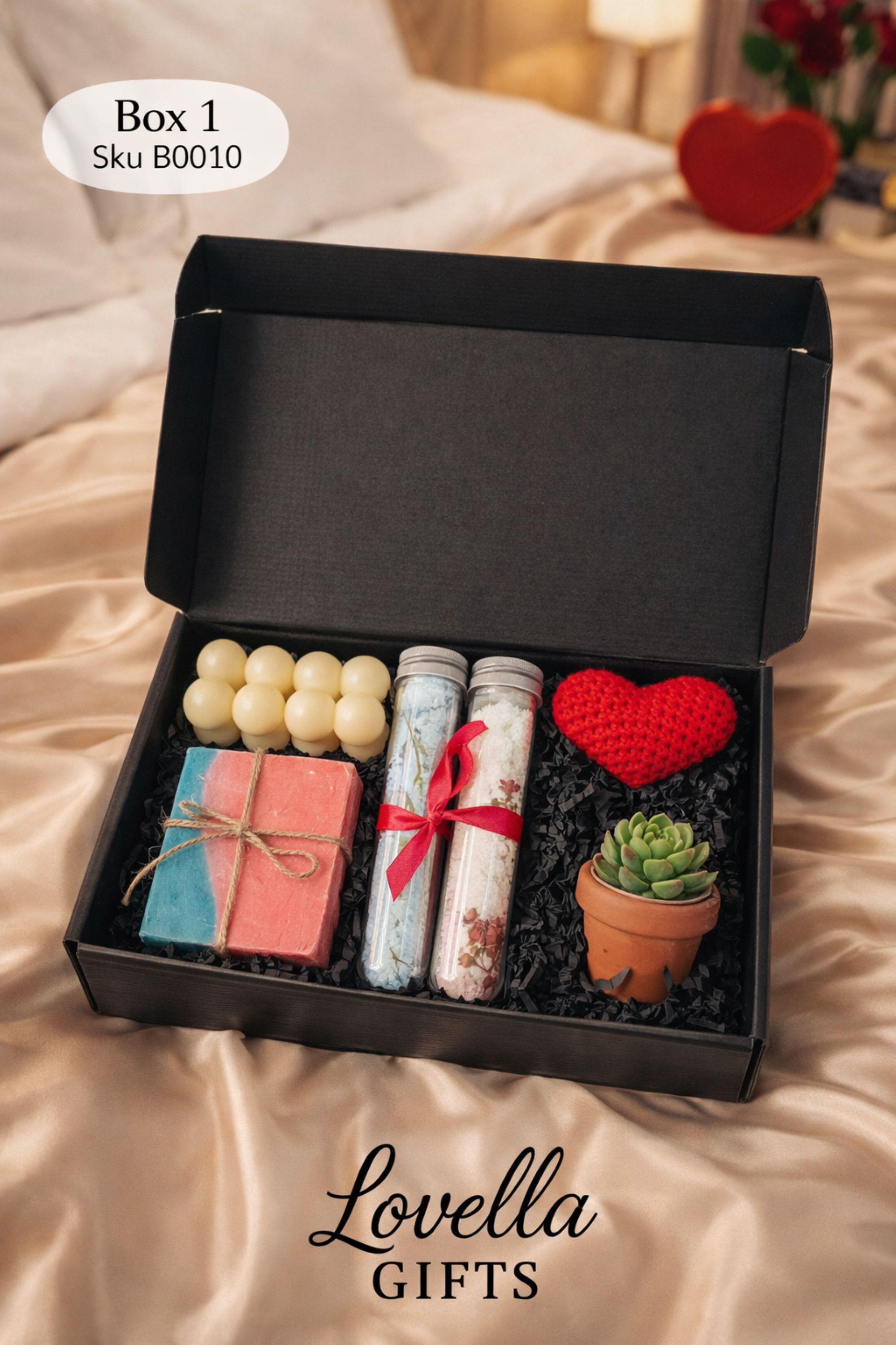 Self love Valentine spa gift box featuring two handmade bubble candles, artisan soap tied with twine, bath salts in glass tubes with ribbon, a crochet heart, and a decorative succulent in a gift box with shredded paper filler. Neutral and calming self care gift for women, ready to gift for Valentine’s Day, self love, thinking of you, or just because occasions. Handmade spa gift with cozy aesthetic.