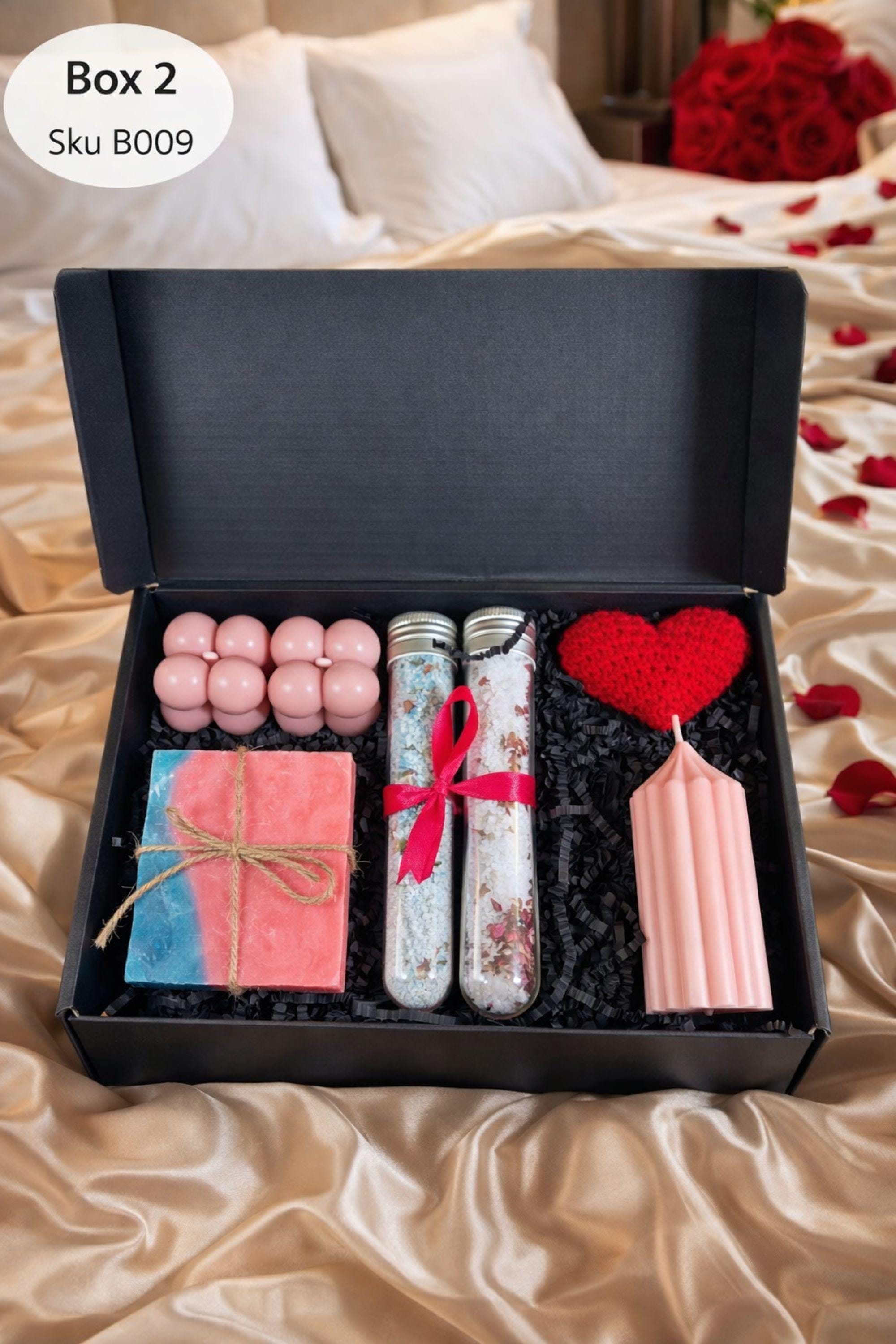 Self love Valentine spa gift box featuring two handmade bubble candles, artisan soap tied with twine, bath salts in glass tubes with ribbon, a crochet heart, and a decorative succulent in a gift box with shredded paper filler. Neutral and calming self care gift for women, ready to gift for Valentine’s Day, self love, thinking of you, or just because occasions. Handmade spa gift with cozy aesthetic.