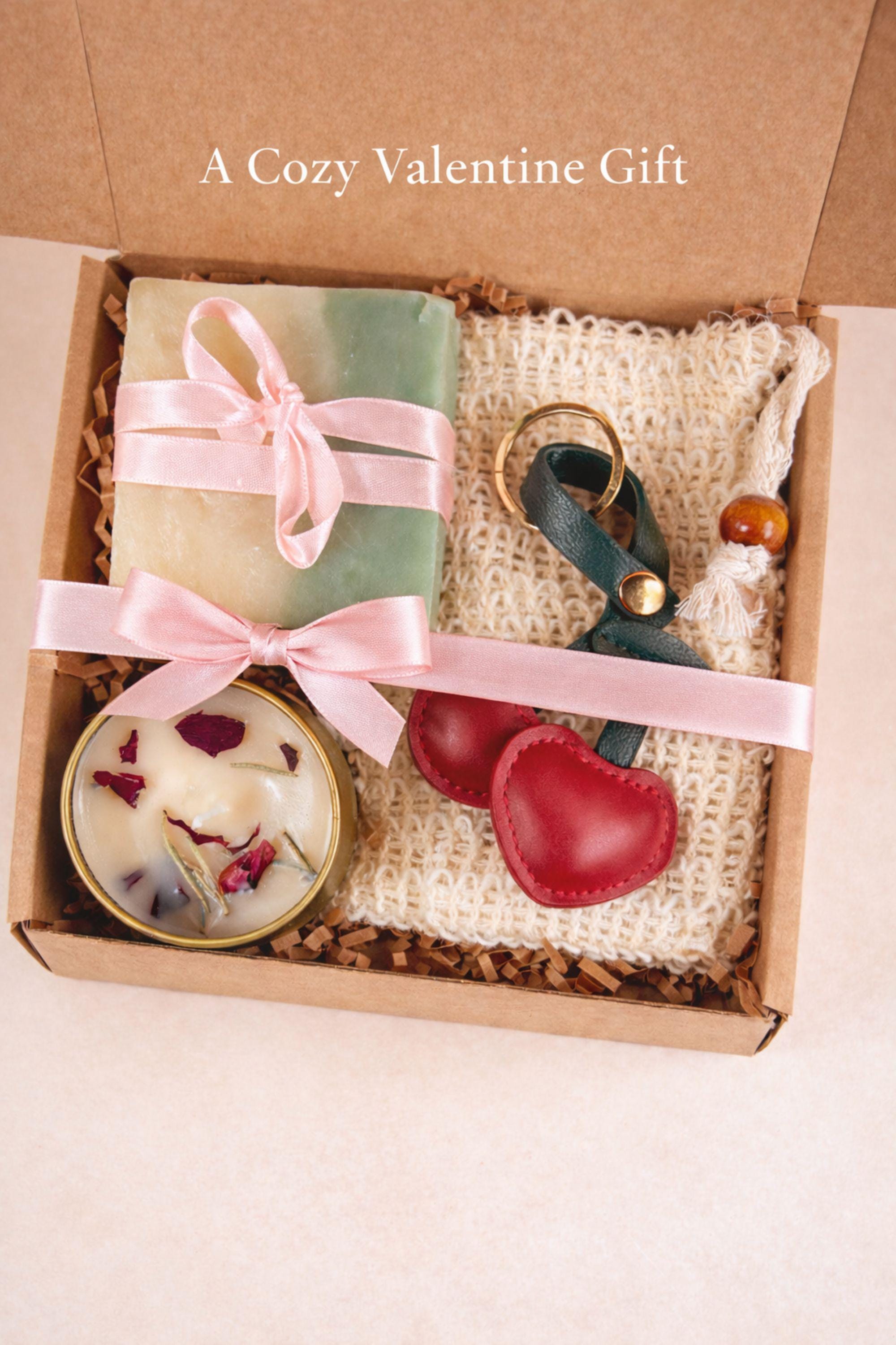 Valentine’s Day thinking of you gift box with handmade soap, botanical candle, crochet washcloth, and leather cherry keychain arranged in a kraft gift box. Cozy Valentine care package featuring artisan soap tied with ribbon, floral candle in tin, soft eco washcloth, and charming heart-inspired cherry accessory. Meaningful Valentine gift for her, long distance Valentine care package, or romantic handmade Valentine present ready to gift.