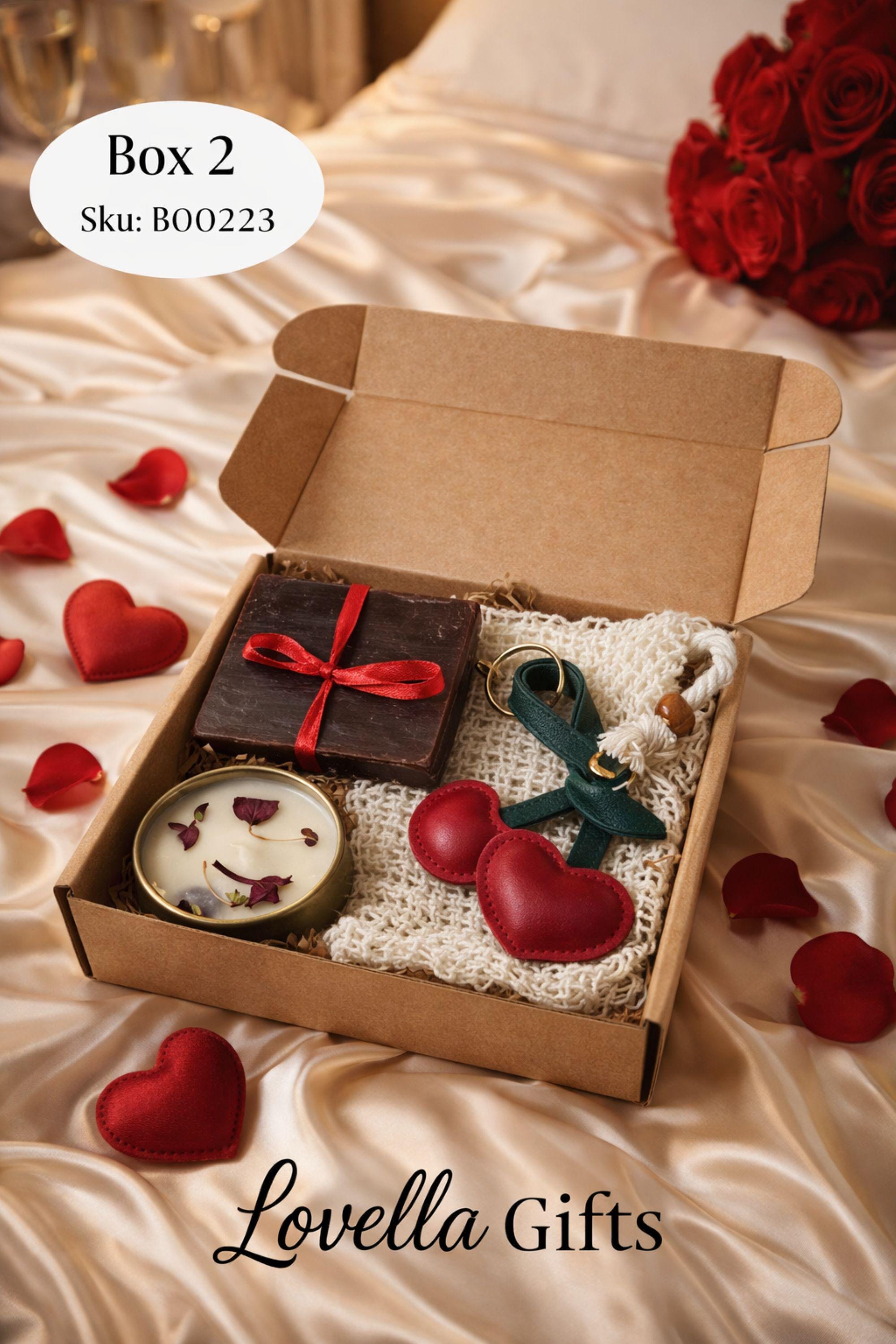 Cozy comfort gift box with handmade soap tied with red ribbon, natural candle in metal tin with dried petals, crocheted washcloth and leather cherry keychain arranged in a kraft box with eco filler. Thoughtful handmade care package perfect as a thinking of you gift, long distance gift, just because present or comforting cozy gift for her. Warm meaningful gift box designed to bring comfort, care and emotional warmth.
