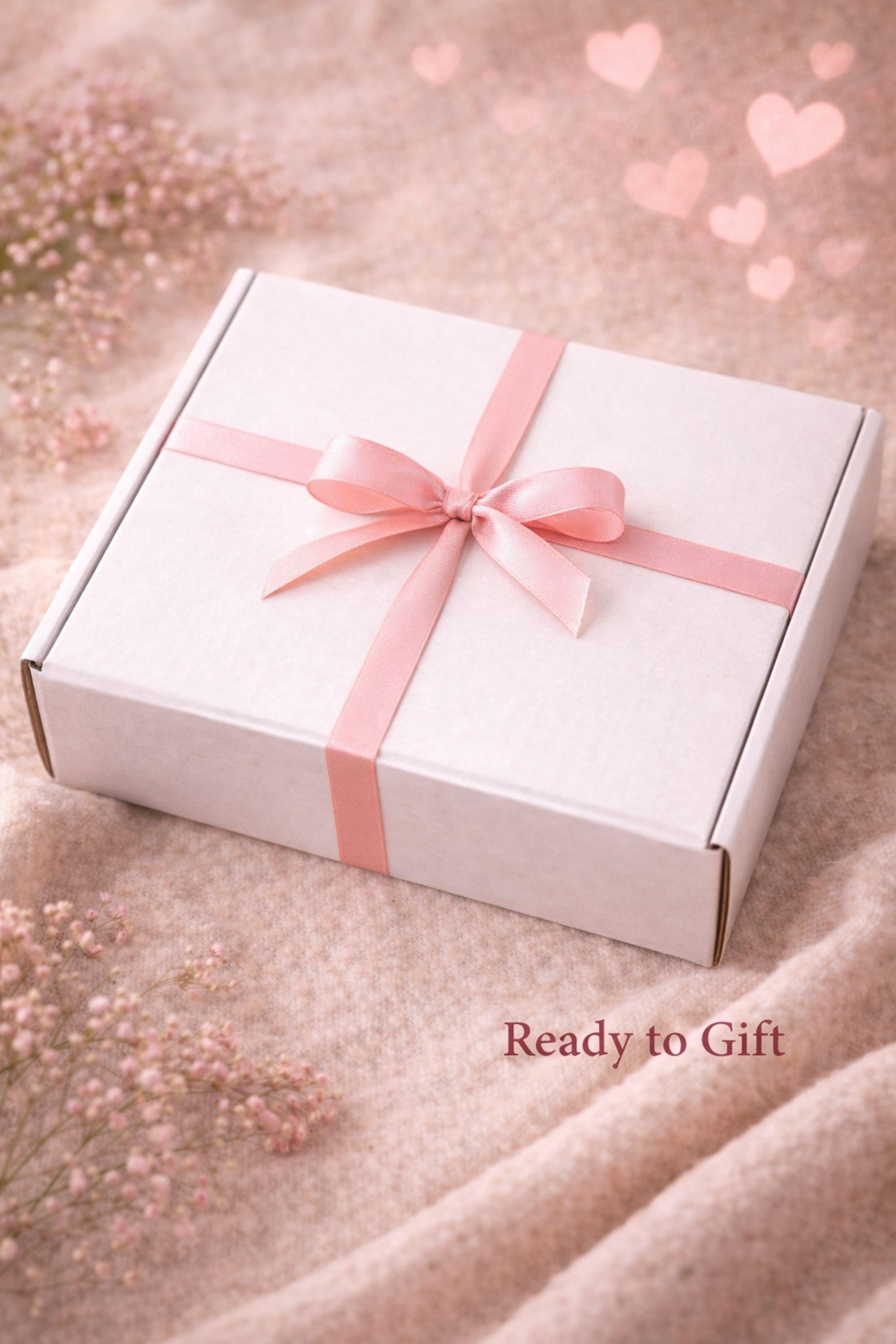 Closed Valentine gift box wrapped with ribbon and ready to gift, placed on a soft neutral fabric background. Handmade Valentine care package prepared as a romantic gift for her, perfect for Valentine’s Day surprises, love gifts, and thoughtful handmade presents that arrive beautifully packaged and ready to give.
