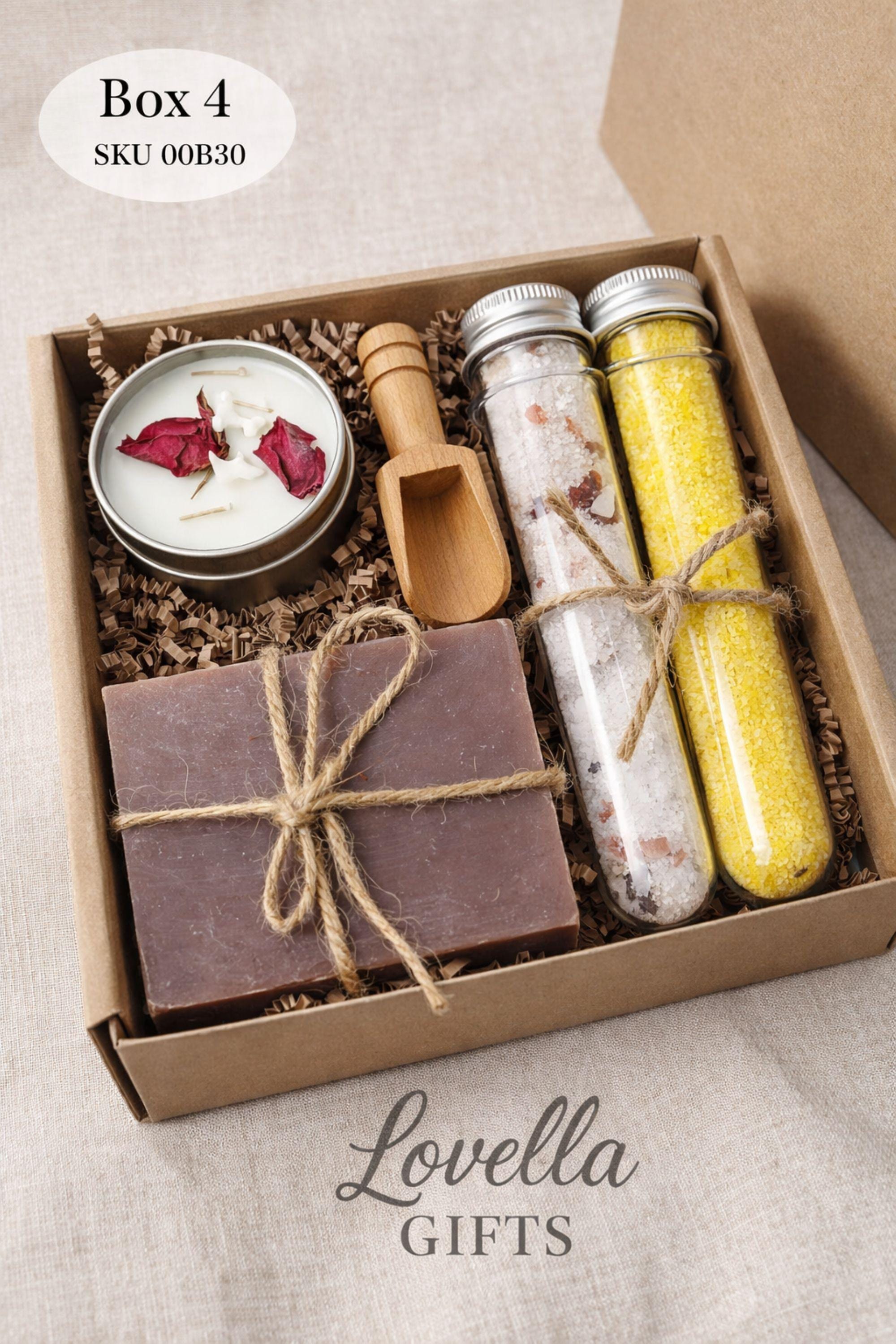 Open handmade gift box for mom displayed on a neutral surface, showing a cozy arrangement of colorful bubble candles, natural soap tied with twine, and two glass tubes of bath salts inside a small 6x6 inch kraft box. Thoughtful gift for mom featuring warm colors and handmade details, designed as a cozy, ready-to-gift present for birthdays, appreciation, or everyday gifting.