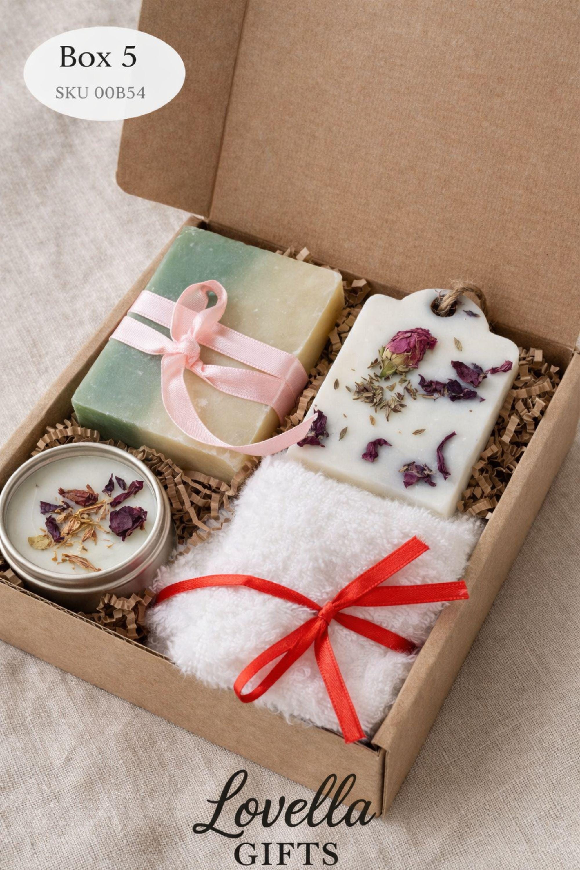 Open minimalist gift box styled in a serene home environment with neutral tones, featuring handmade sage candles, soap, and bath salts. Cozy home gift set designed for everyday calm, slow living, and simple self care routines, offering a peaceful handmade candle and soap set that fits naturally into a minimalist interior.