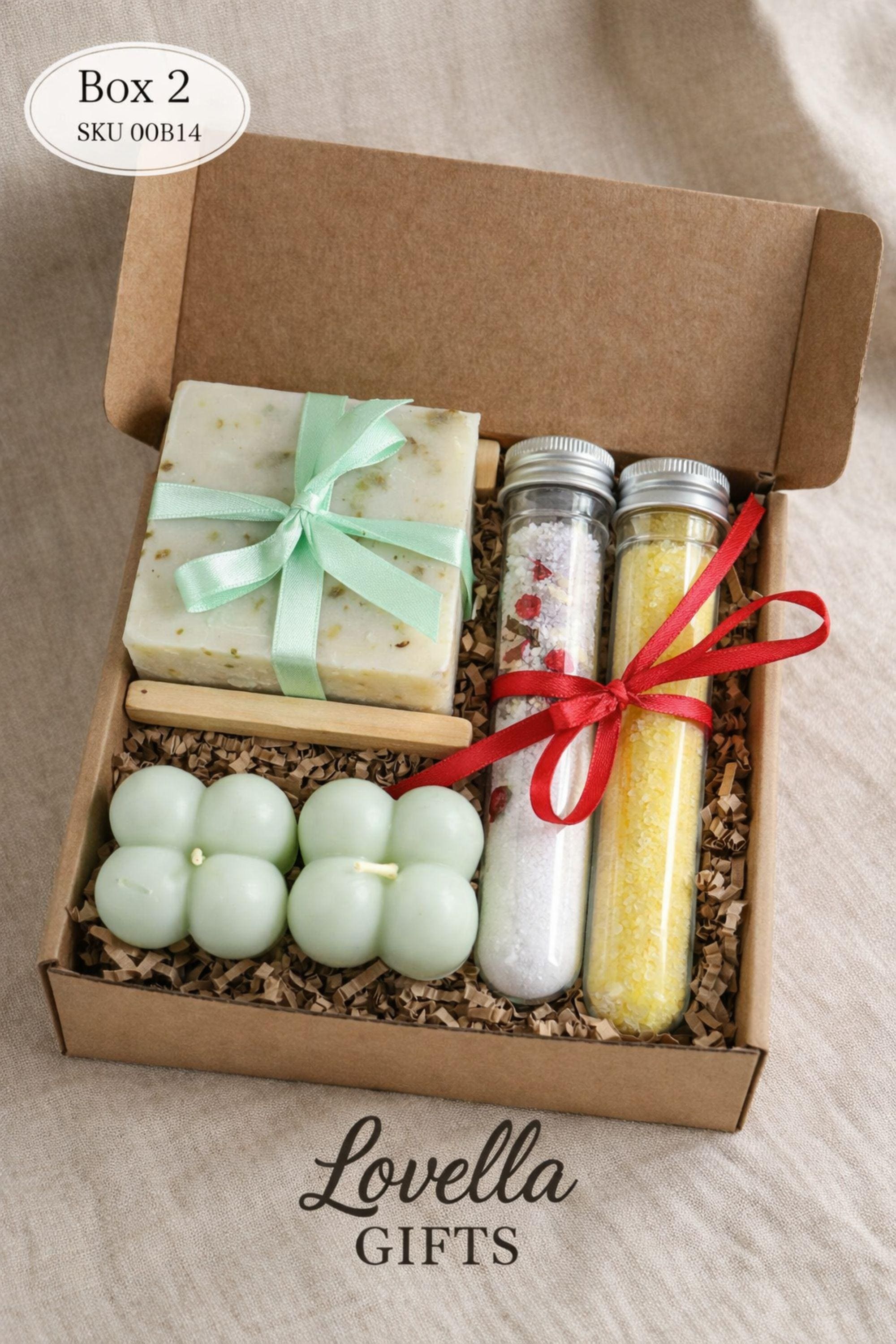 Open handmade gift box for mom displayed on a neutral surface, showing a cozy arrangement of colorful bubble candles, natural soap tied with twine, and two glass tubes of bath salts inside a small 6x6 inch kraft box. Thoughtful gift for mom featuring warm colors and handmade details, designed as a cozy, ready-to-gift present for birthdays, appreciation, or everyday gifting.