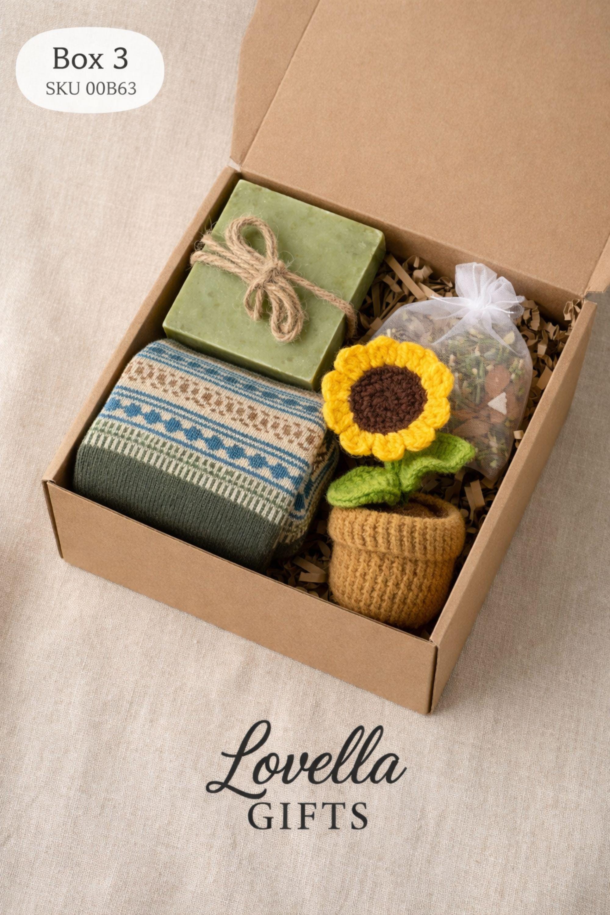 Open handmade gift box for mom displayed on a neutral surface, showing a cozy arrangement of cozy socks, natural soap tied with twine, and bath salt, crochet flower inside a small 6x6 inch kraft box. Thoughtful gift for mom featuring warm colors and handmade details, designed as a cozy, ready-to-gift present for birthdays, appreciation, or everyday gifting.