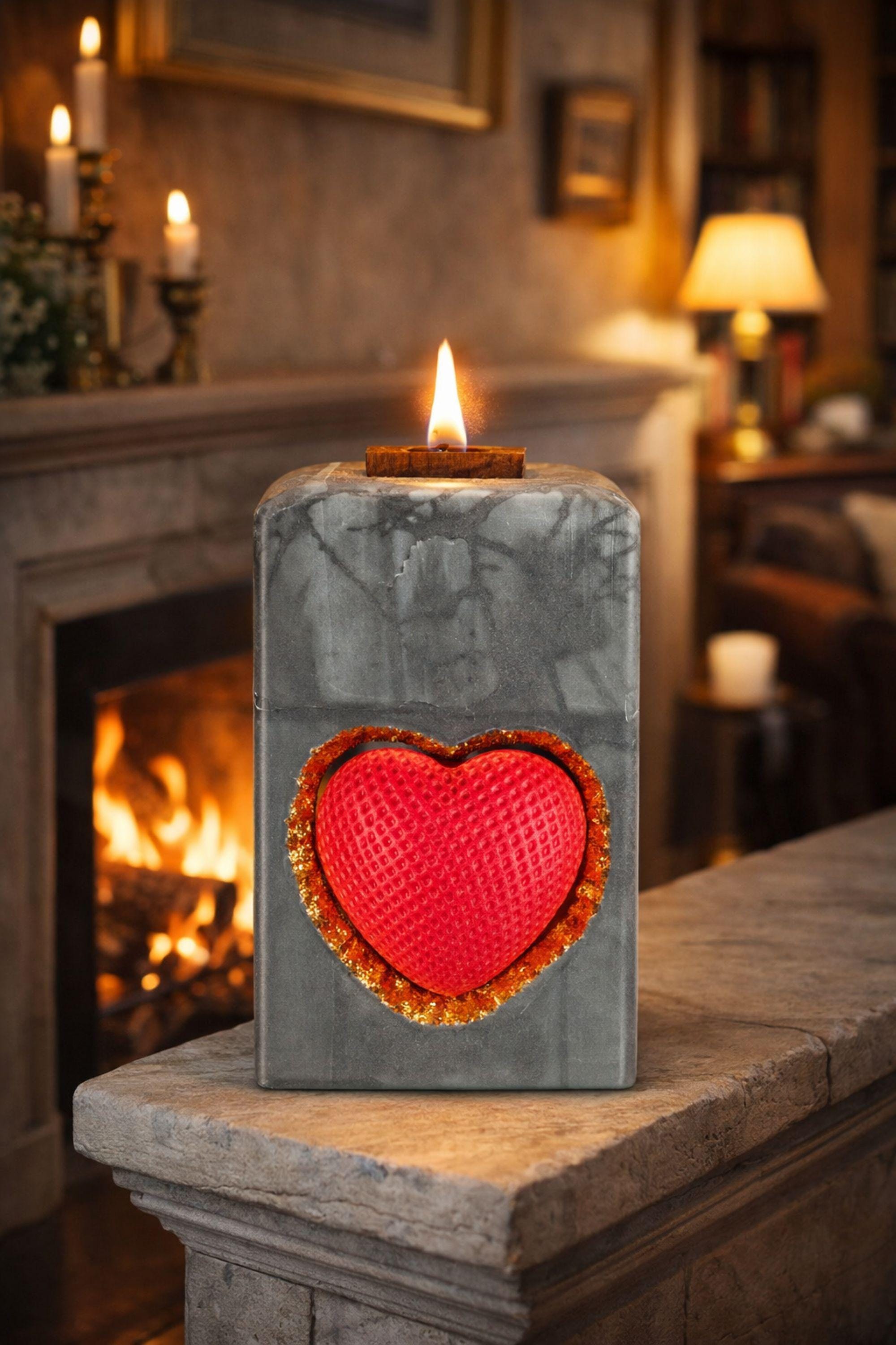Luxury grey statement candle with a red textured heart framed in gold, handcrafted designer candle created as a romantic gift and modern decor object. This luxury heart candle is designed as a meaningful anniversary or Valentine’s gift for her, combining sculptural form, stone-inspired texture, and gold detail for a centerpiece candle look.