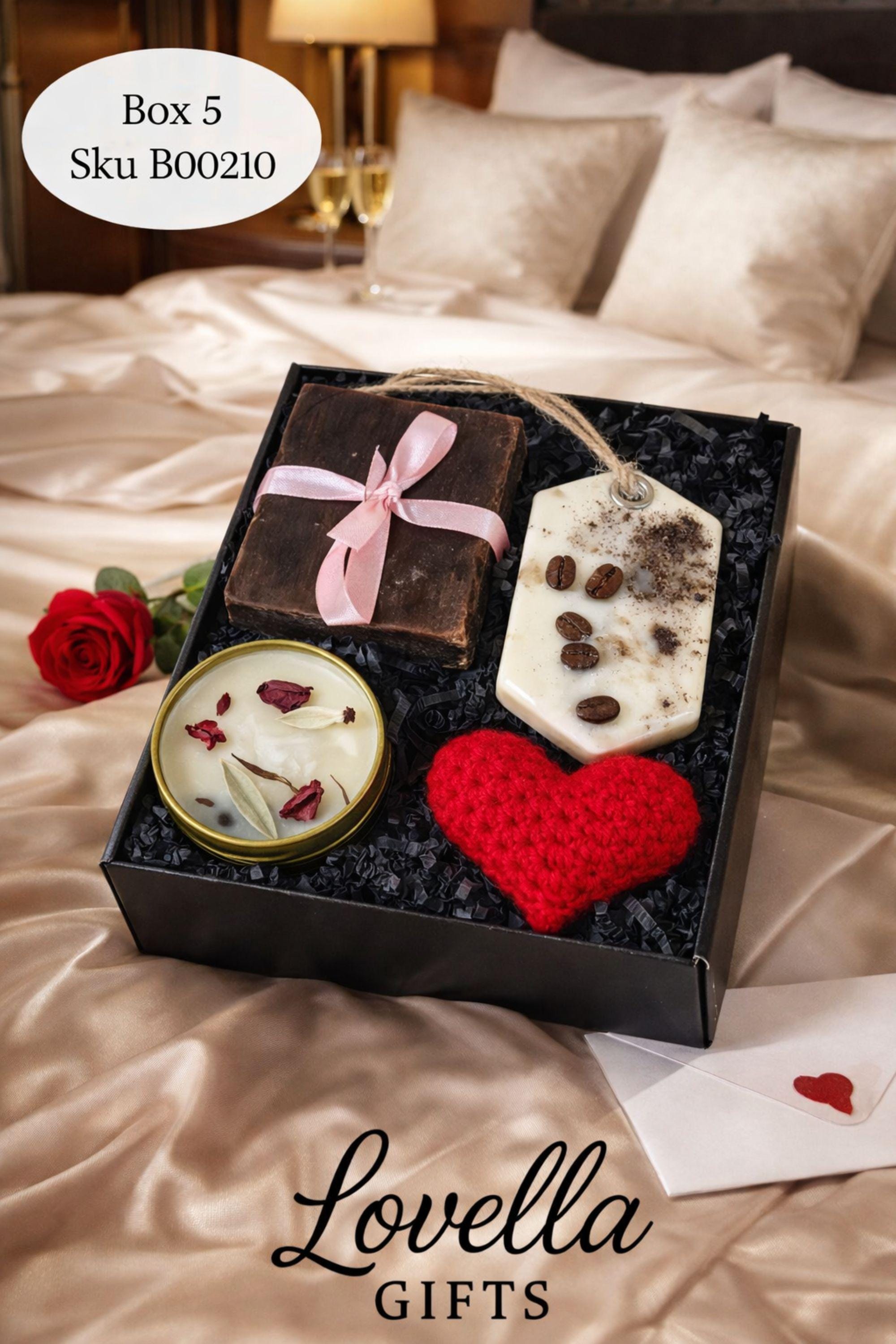 Cozy Valentine gift box with handmade soap tied with red ribbon, heart shaped candle, scented candle with dried flowers, bath salts in glass tubes, and knitted washcloth arranged in kraft gift box. Romantic self care gift for her, comfort care package, handmade Valentine’s Day gift, thinking of you box, ready to gift cozy relaxation set.