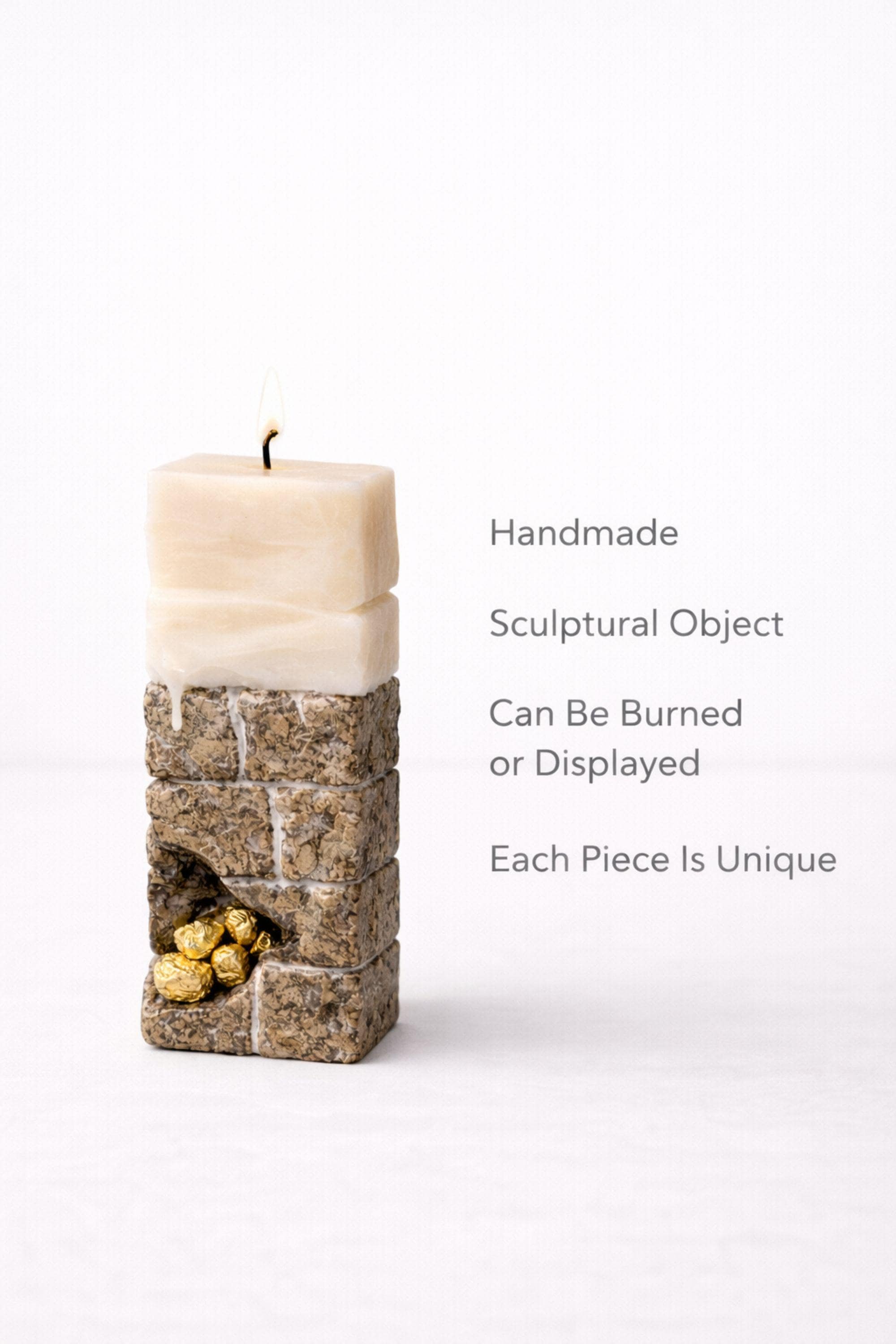 Minimalist sculptural candle designed as a modern luxury home decor object, featuring an architectural wax form, stone inspired texture, and subtle 24 karat gold plated detail. This handmade statement candle functions as both decorative sculpture and functional candle, ideal for minimalist interiors, modern home styling, designer shelf decor, console table accents, luxury gift ideas, and curated contemporary spaces. One of a kind handmade wax art piece.