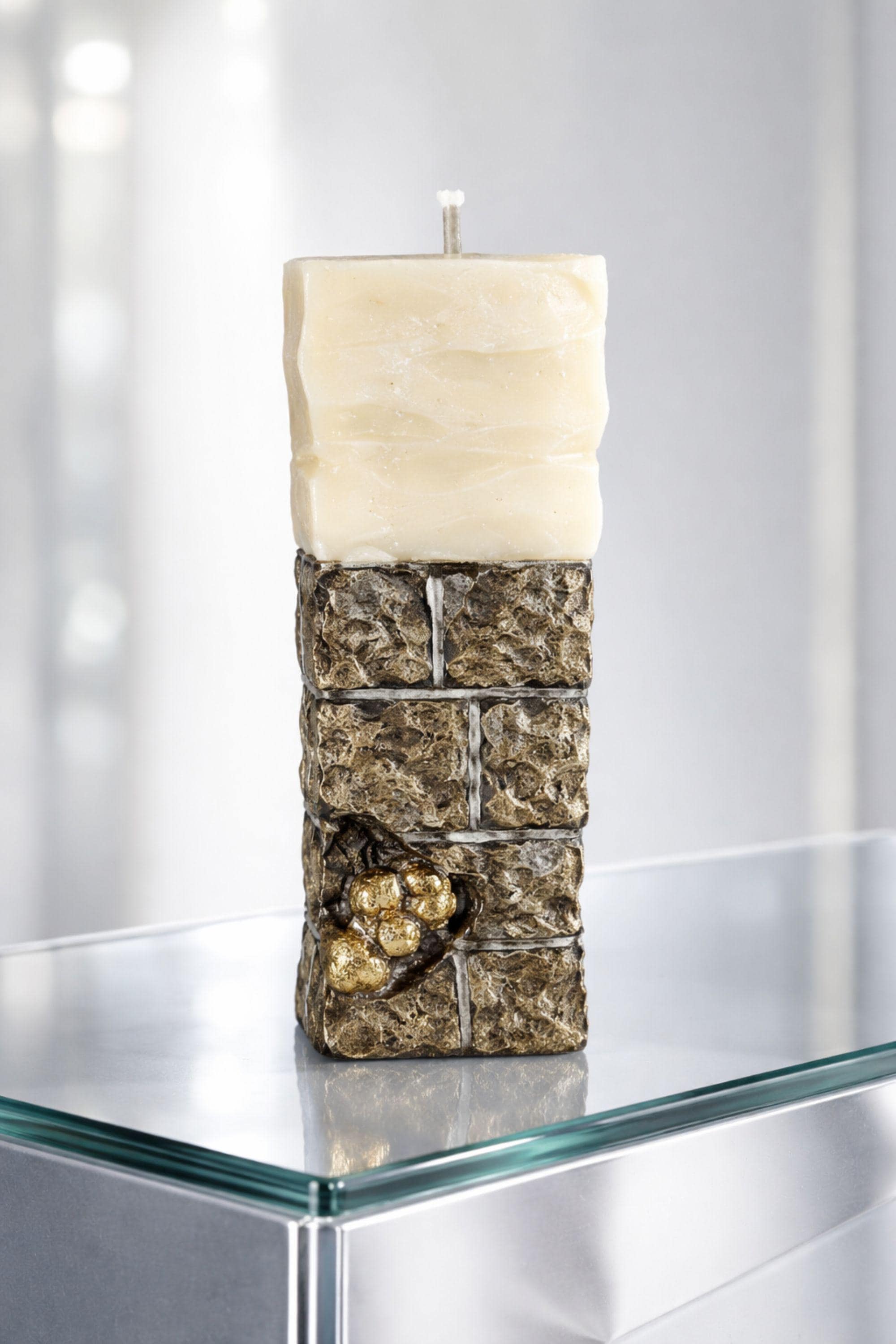 Minimalist sculptural candle designed as a modern luxury home decor object, featuring an architectural wax form, stone inspired texture, and subtle 24 karat gold plated detail. This handmade statement candle functions as both decorative sculpture and functional candle, ideal for minimalist interiors, modern home styling, designer shelf decor, console table accents, luxury gift ideas, and curated contemporary spaces. One of a kind handmade wax art piece.