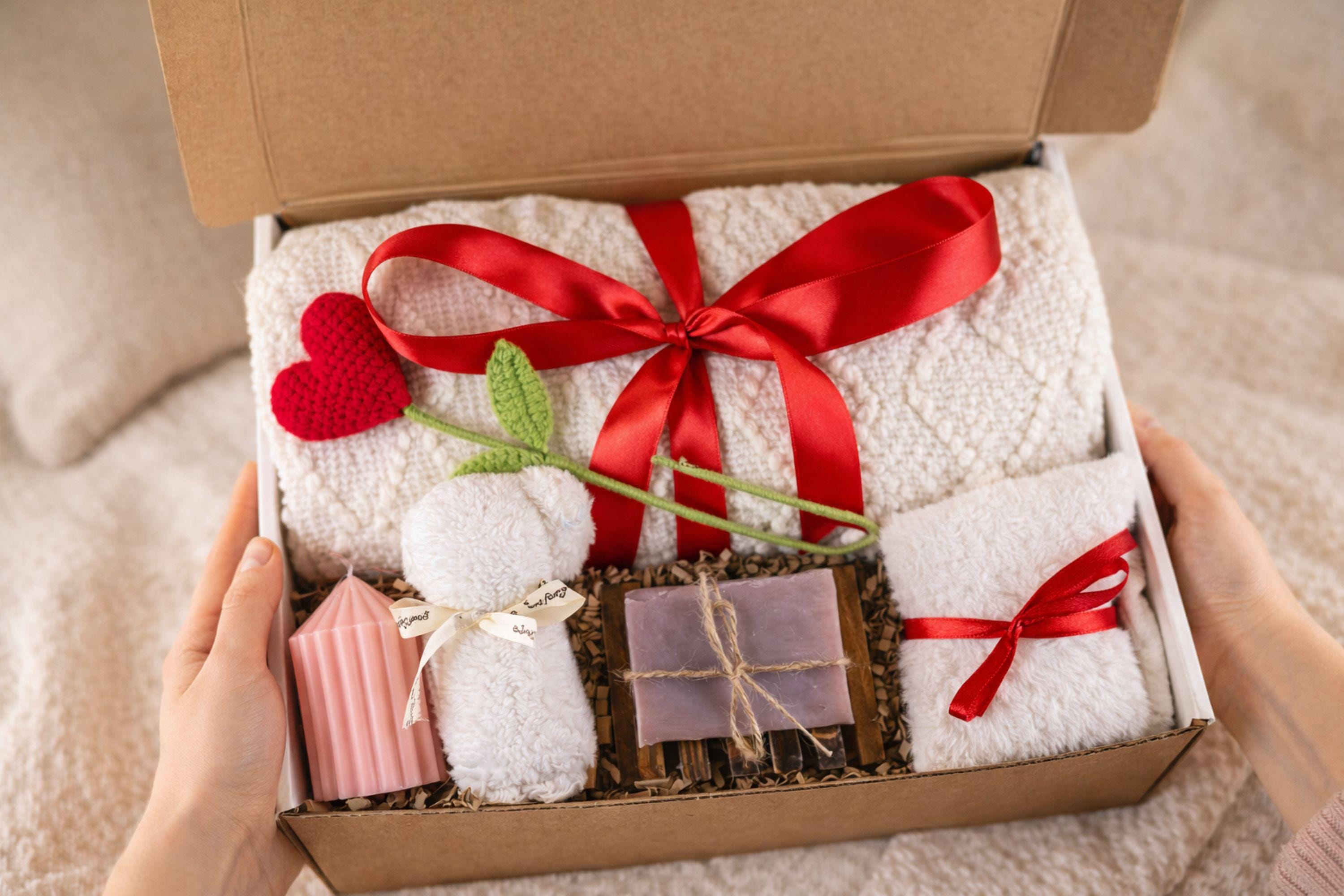 Valentine gift box with soft cozy blanket, candle, handmade soap, plush comfort items, and romantic heart details arranged in a gift-ready box. This cozy romantic Valentine care package is designed to send love, warmth, and comfort, perfect for long distance Valentine gifting, self love moments, or a thoughtful romantic surprise for her.