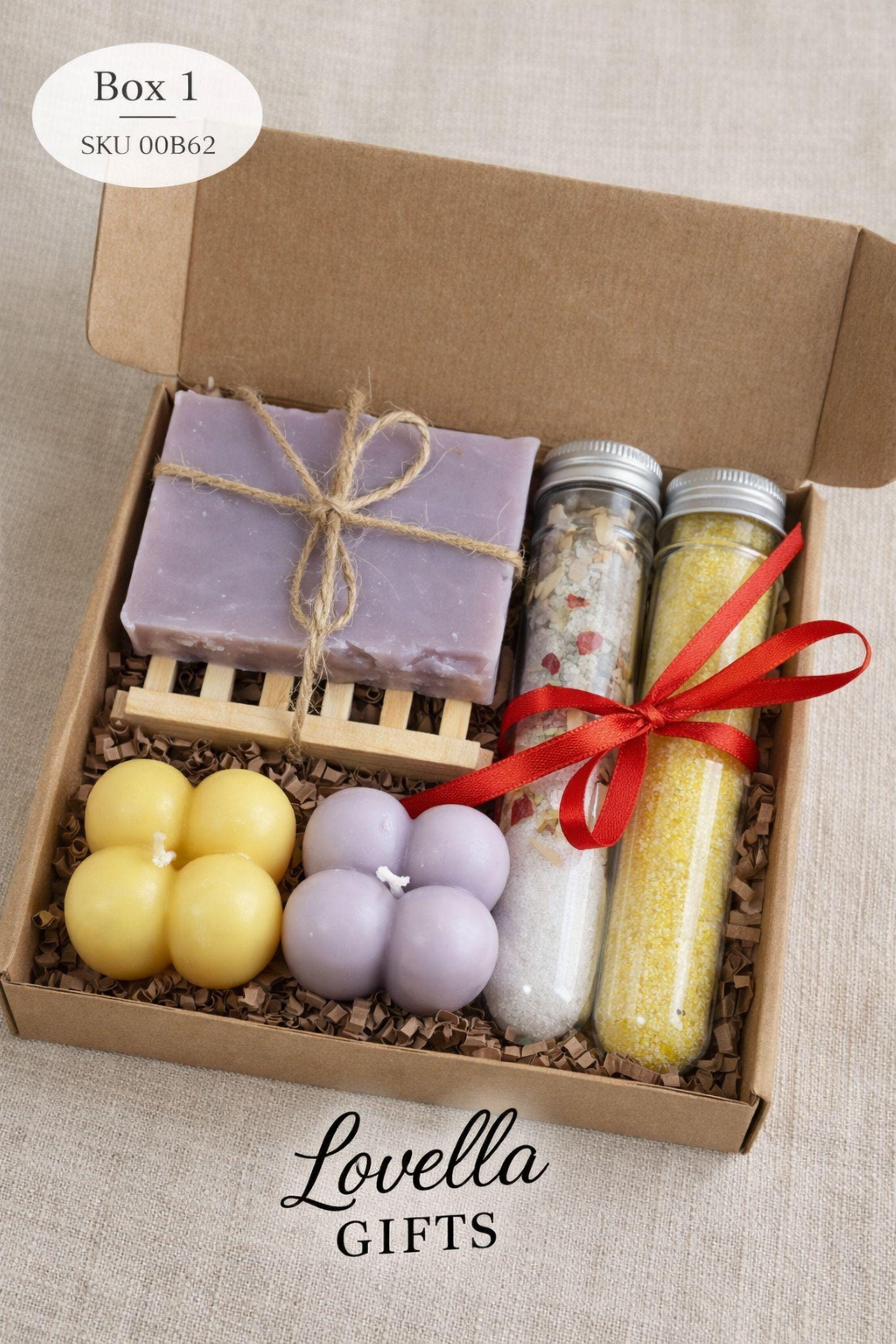 Detailed view of an open handmade gift box for mom highlighting the arrangement of colorful bubble candles, bath salt tubes, and natural soap. Emphasis on the compact 6x6 inch size, handmade quality, and careful presentation of this thoughtful and cozy gift.
