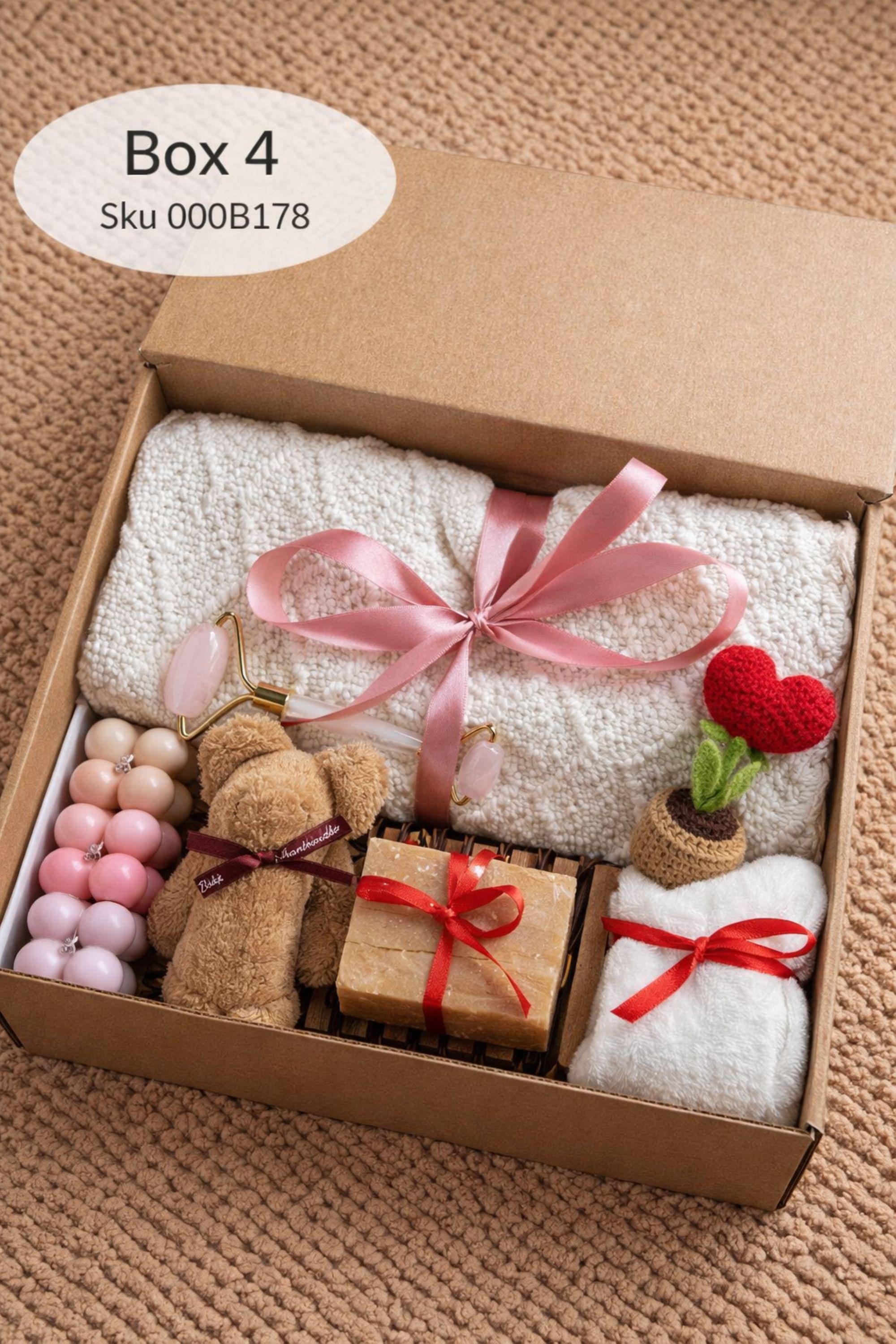Large cozy blanket gift box with handmade candles, soap, plush socks, and soft bear-shaped face cloth arranged in a white gift box. A rolled cream blanket tied with red ribbon sits at the back, paired with a heart candle, pillar candle, artisan soap, crochet heart and flower, and cozy accessories. A warm self care comfort gift ideal for Valentine’s Day, birthdays, or sending love and relaxation.