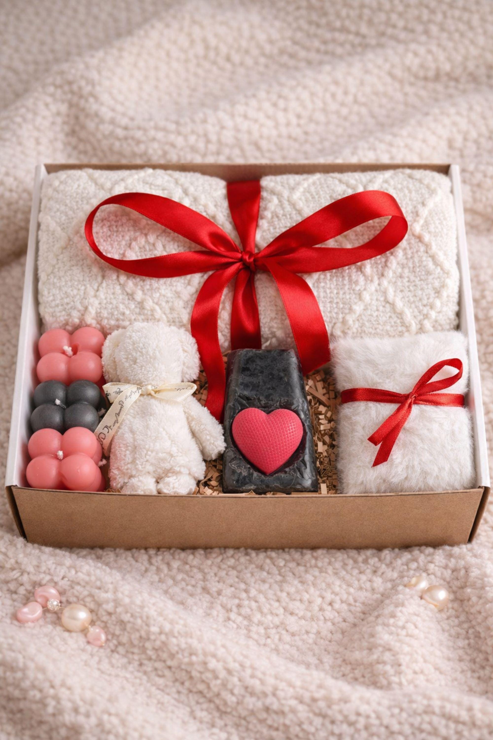 Cozy Valentine gift box for her displayed on a soft cream knitted background, featuring handmade bubble candles, a heart-shaped artisan soap, plush cozy bear, and spa-inspired self care items arranged in a gift-ready box. This romantic Valentine care package is a thoughtful self care gift for girlfriend, wife, sister, or loved one, designed to send comfort, warmth, and love with handmade details and ready-to-gift packaging.