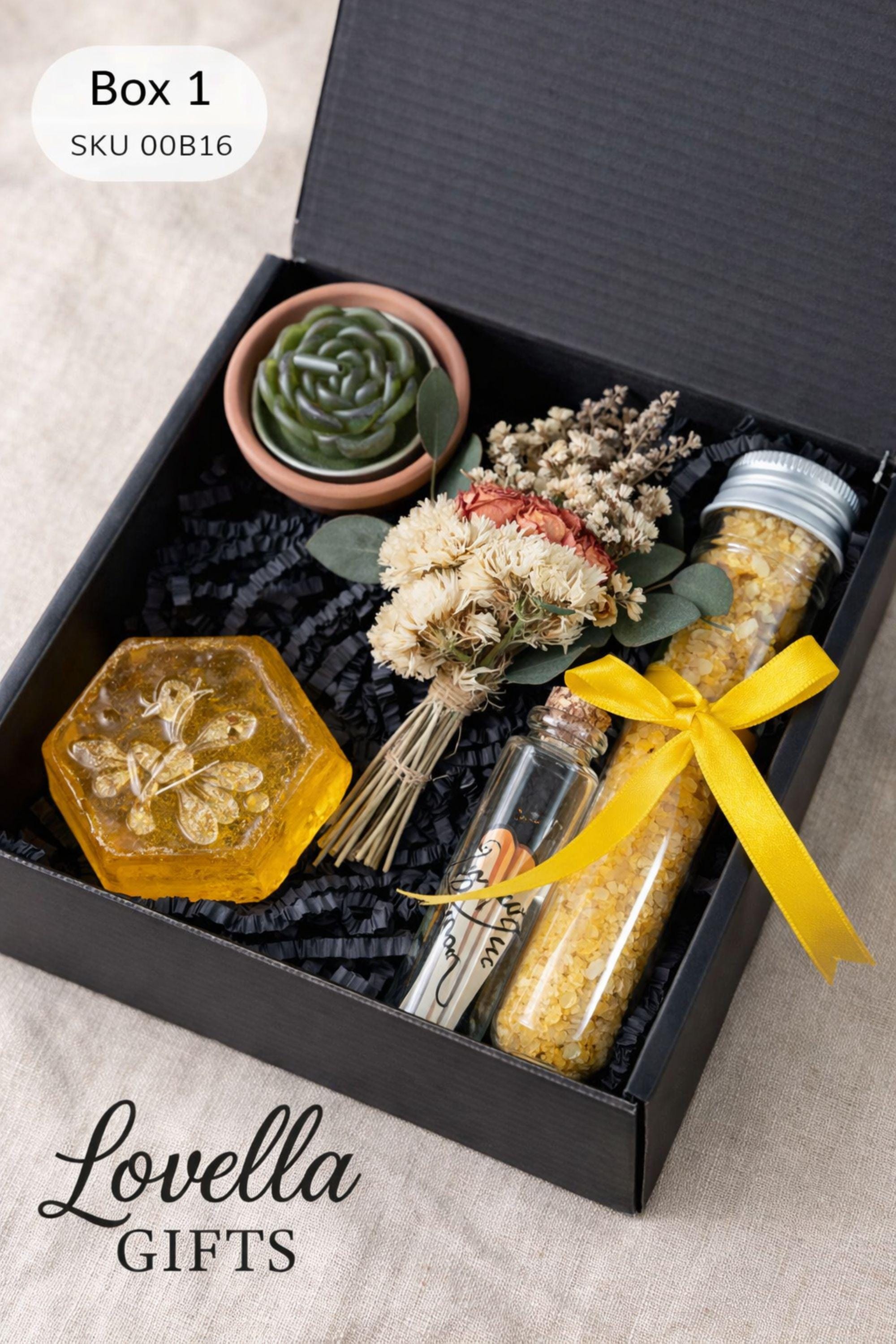 Pet loss sympathy gift box with memorial candle, honey soap, dried flowers, bath salts and matches arranged in elegant black gift box. Comfort care package designed as dog or cat memorial gift for grieving pet owner. Thoughtful pet bereavement gift with remembrance candle and self care elements to offer support after the loss of a beloved pet.